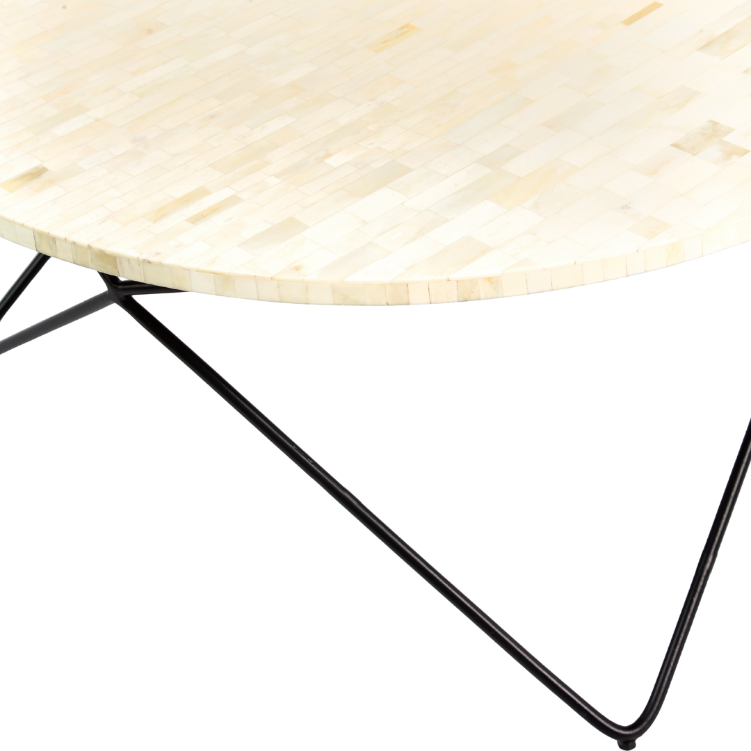 Ivory bone carved coffee table with linear textured surface and angular black metal base by Tabeer Homes.
