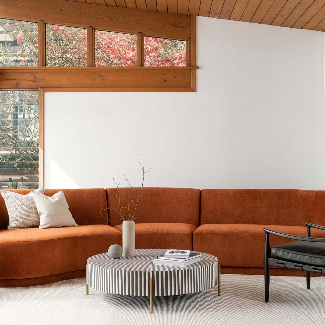 Round black bone inlay coffee table with striped design and brass legs