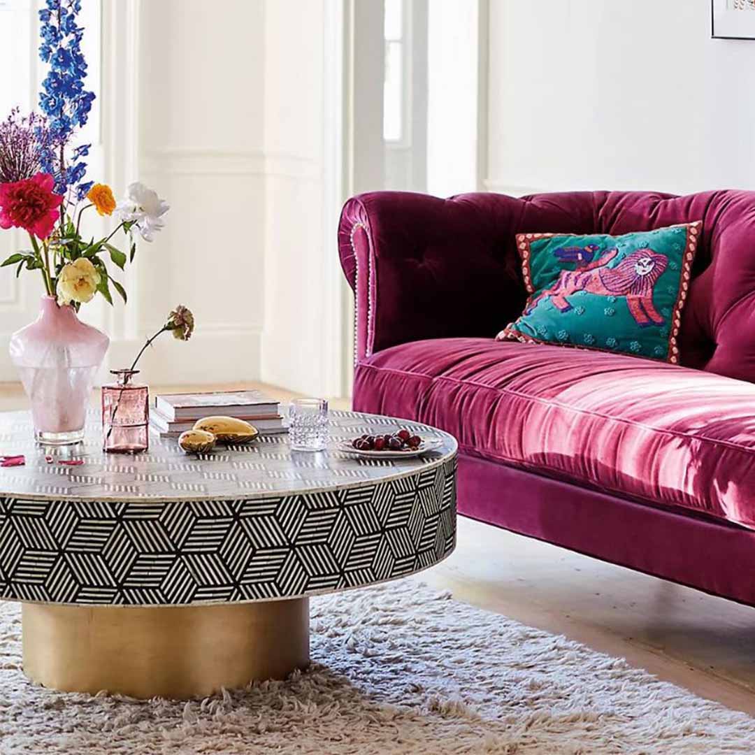 Round black bone inlay coffee table with a bold geometric pattern and gold base. A modern centerpiece for elegant living spaces.