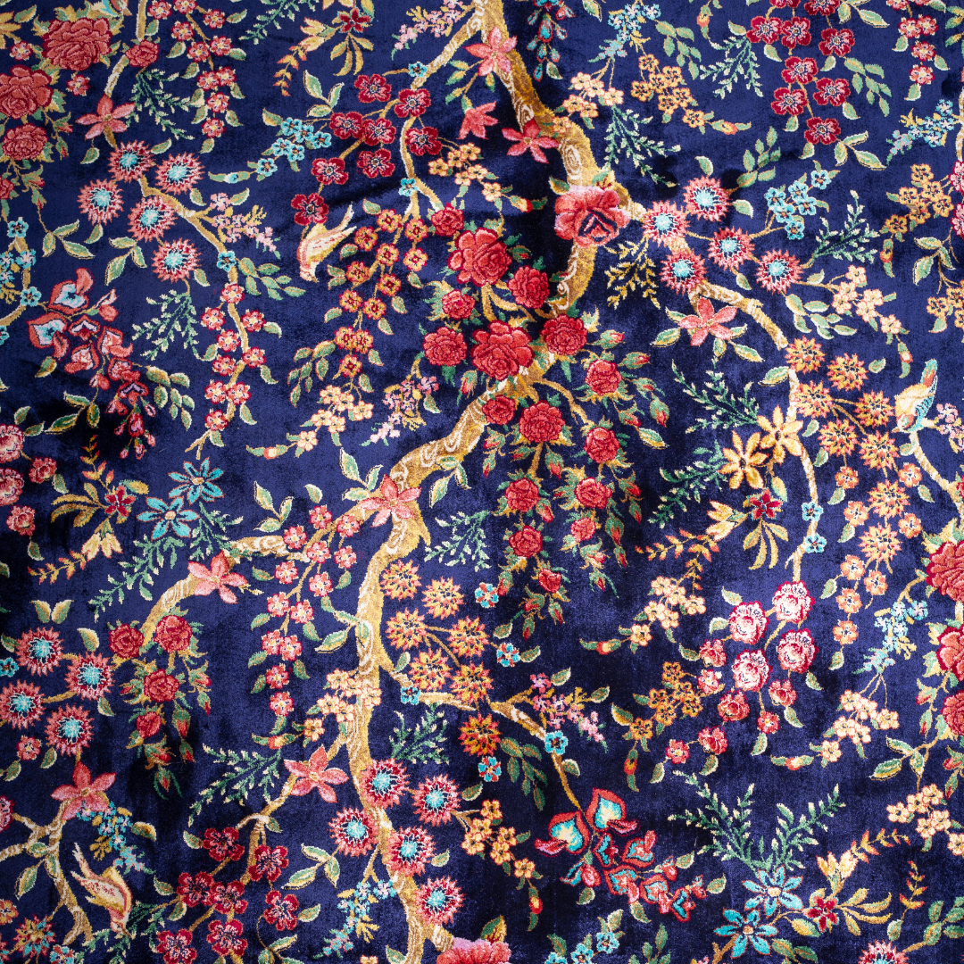 Silk Persian rug in navy with crimson, pink, jade, and gold floral design. Tree-of-life motif. Size: 225x150 cm. Ships worldwide.