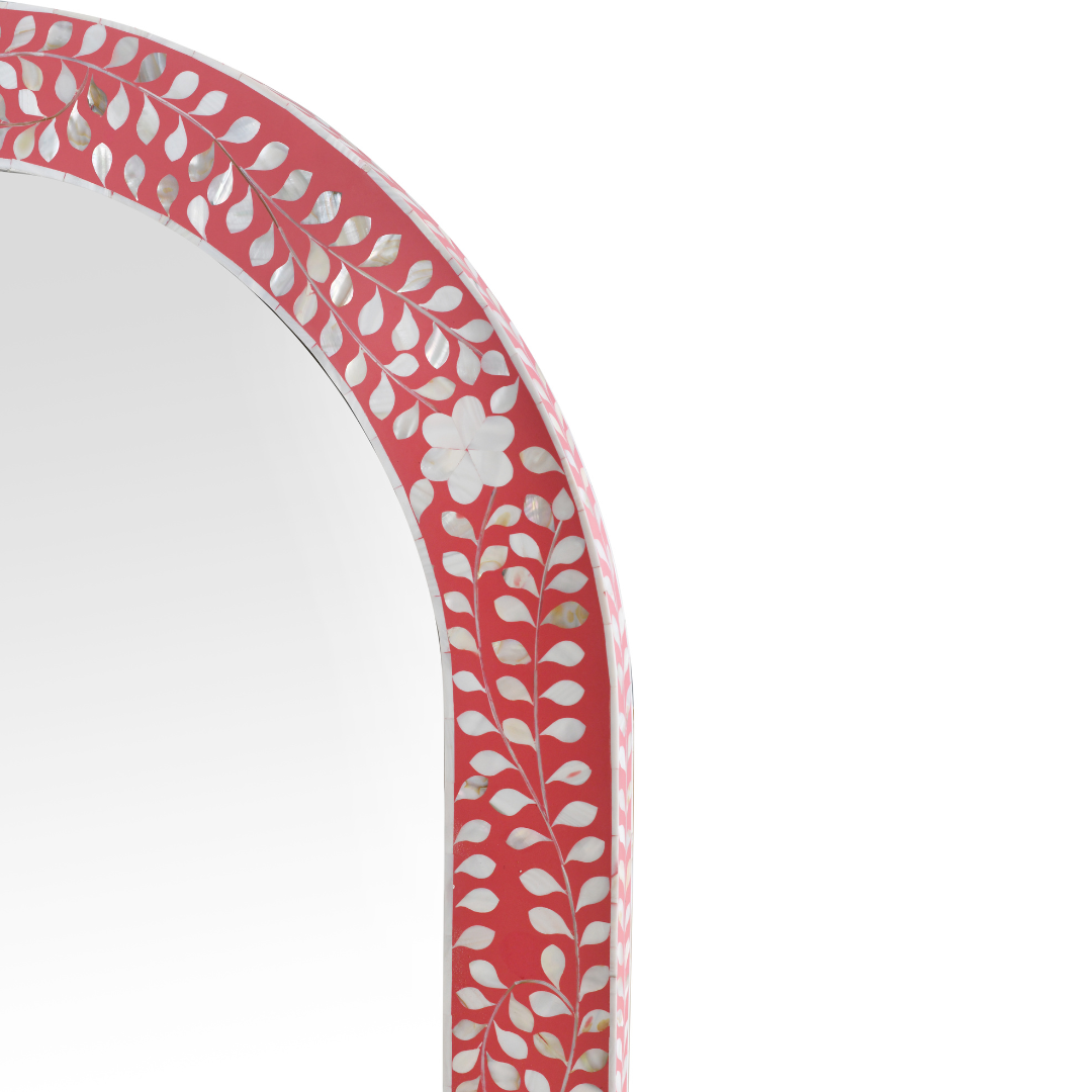Handcrafted arched mirror with pink mother of pearl inlay, featuring intricate floral and vine detailing on a sleek frame.