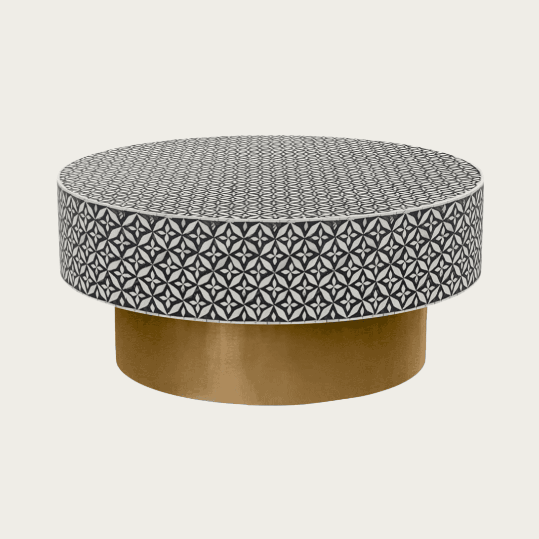 Round black bone inlay coffee table with intricate floral pattern and bold gold base. A modern, stylish centerpiece for any room.