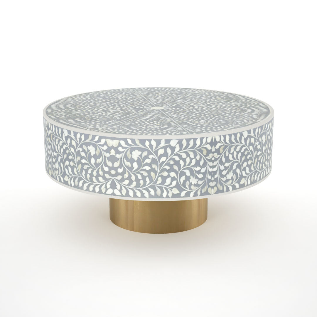 Round grey bone inlay coffee table with floral design and a gold base