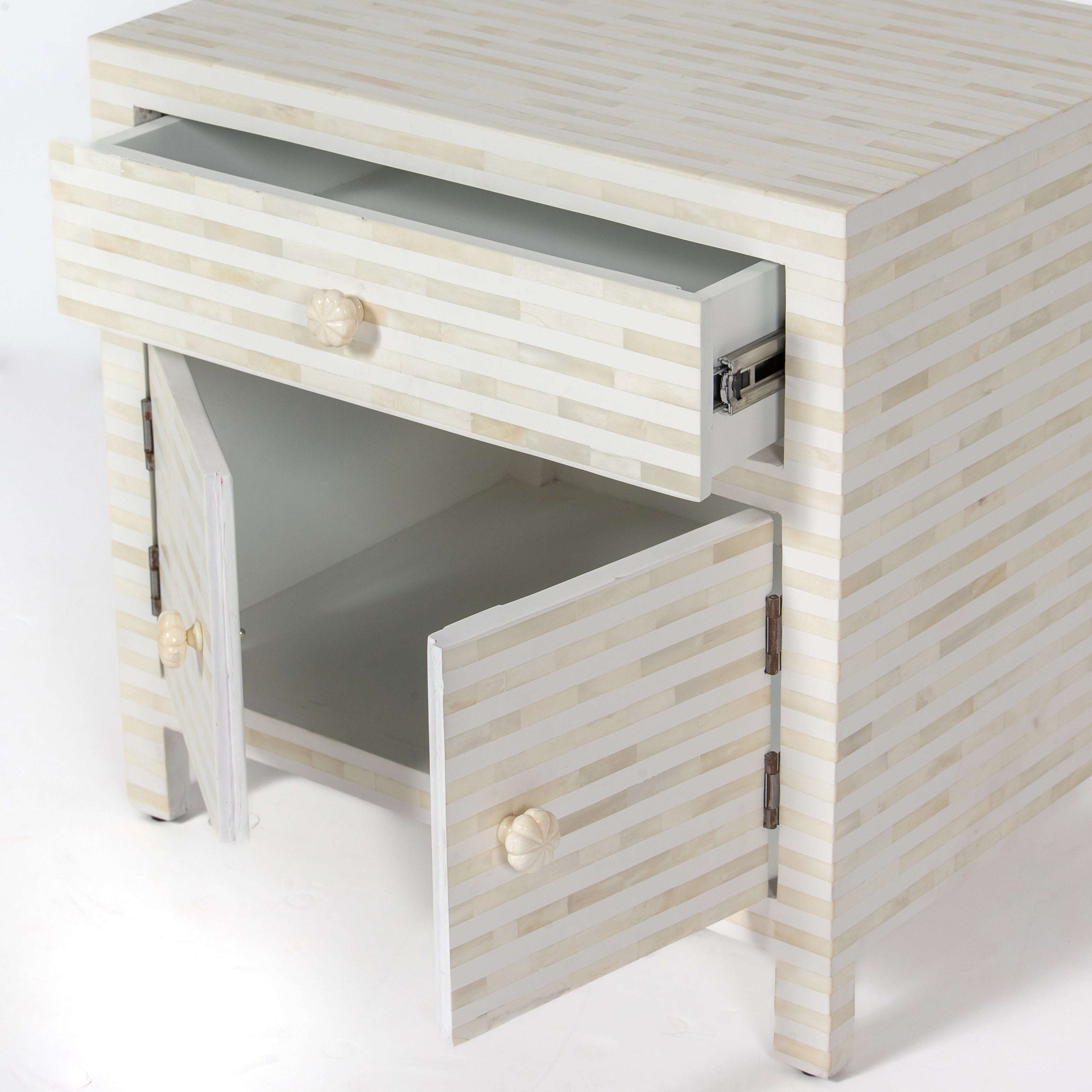 The Saphed Side Drawer features white bone inlay with cabinet doors and a drawer. A graceful accent for luxury interiors.