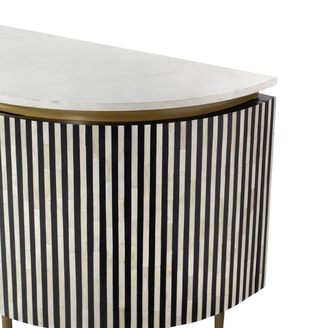 Black bone inlay sideboard with white marble top and brass legs, handcrafted with vertical striping and curved silhouette, luxury interior furniture.