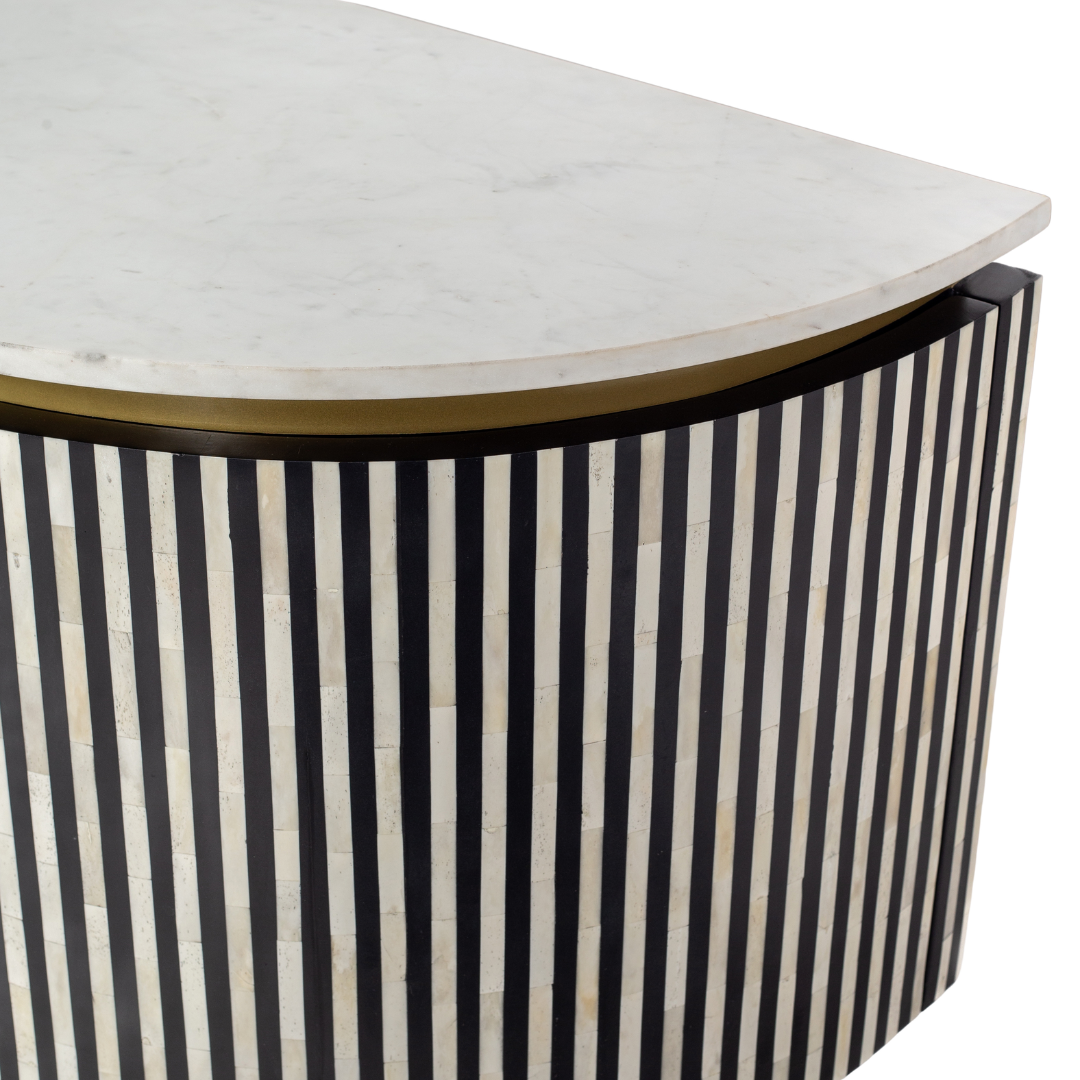 Black bone inlay sideboard with white marble top and brass legs, handcrafted with vertical striping and curved silhouette, luxury interior furniture.