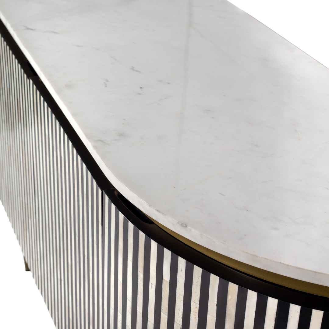 Black bone inlay sideboard with white marble top and brass legs, handcrafted with vertical striping and curved silhouette, luxury interior furniture.