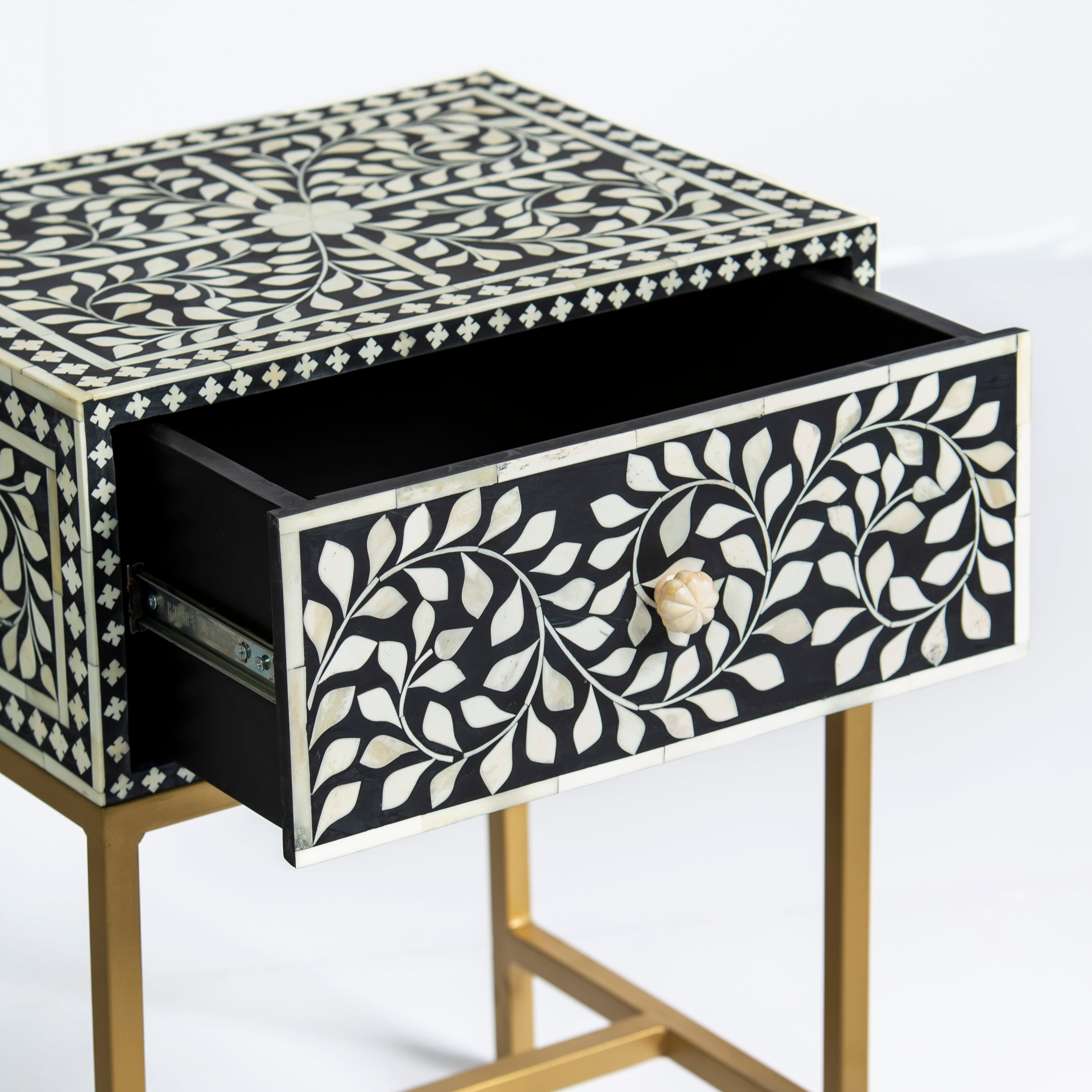 Bone inlay side drawer featuring floral vine pattern in black and white with metal base, handcrafted furniture piece