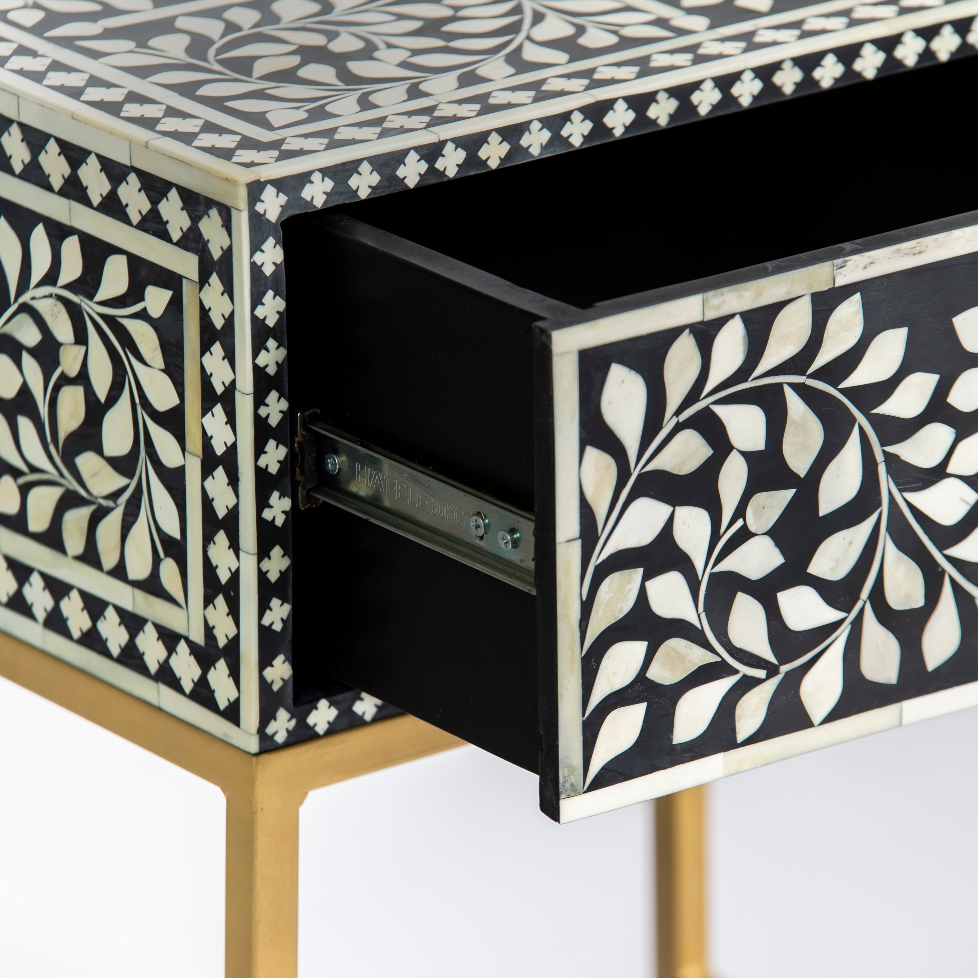 Bone inlay side drawer featuring floral vine pattern in black and white with metal base, handcrafted furniture piece