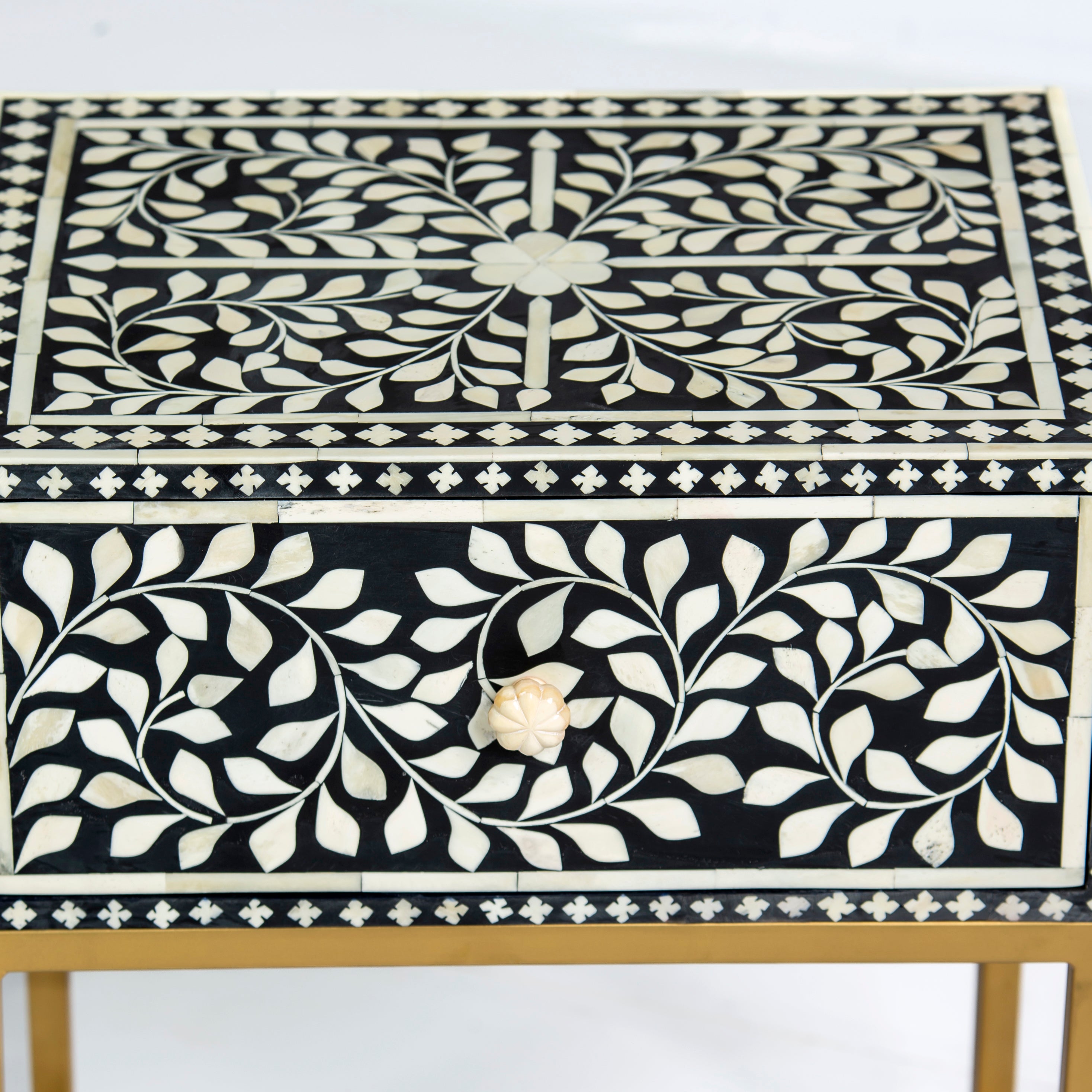 Bone inlay side drawer featuring floral vine pattern in black and white with metal base, handcrafted furniture piece