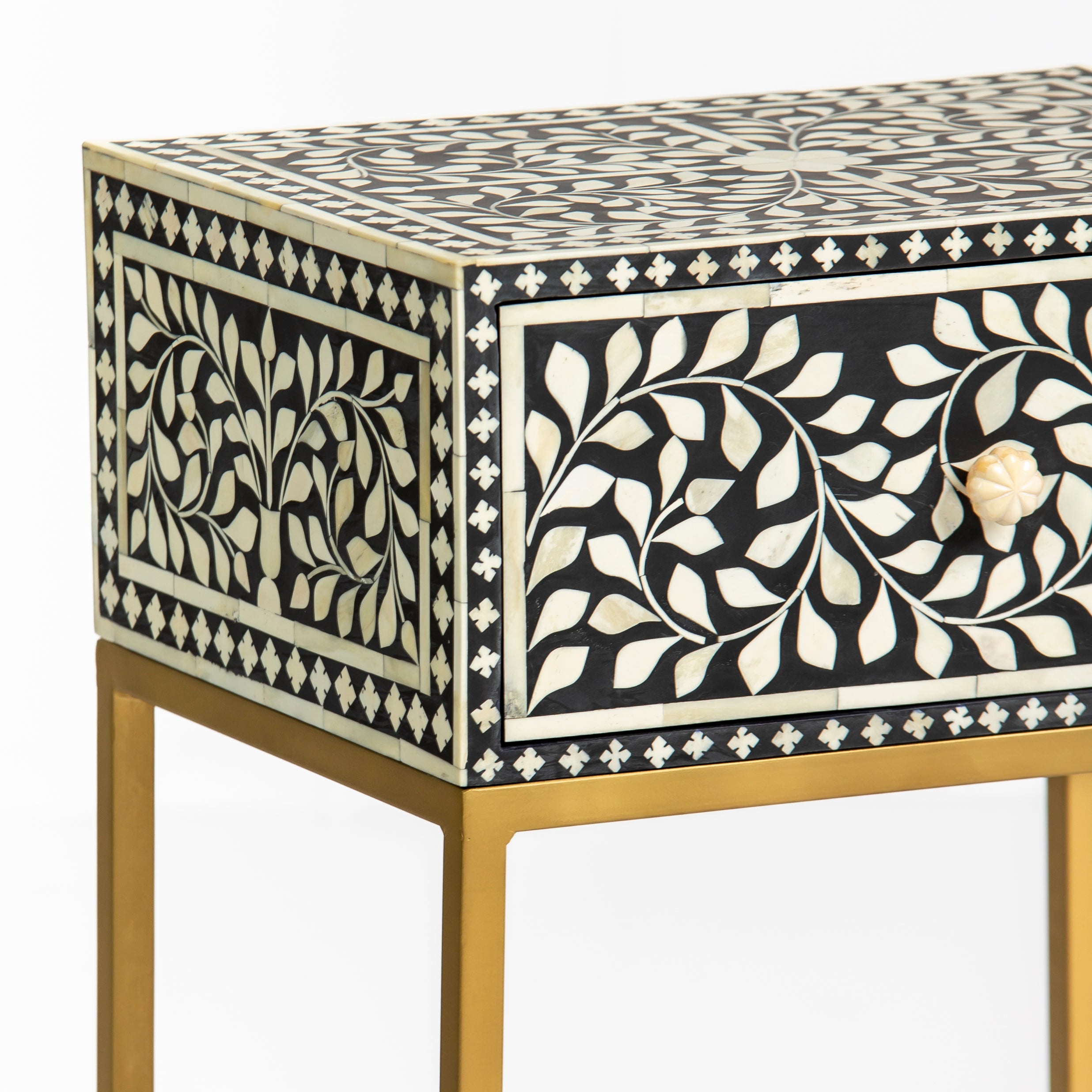 Bone inlay side drawer featuring floral vine pattern in black and white with metal base, handcrafted furniture piece