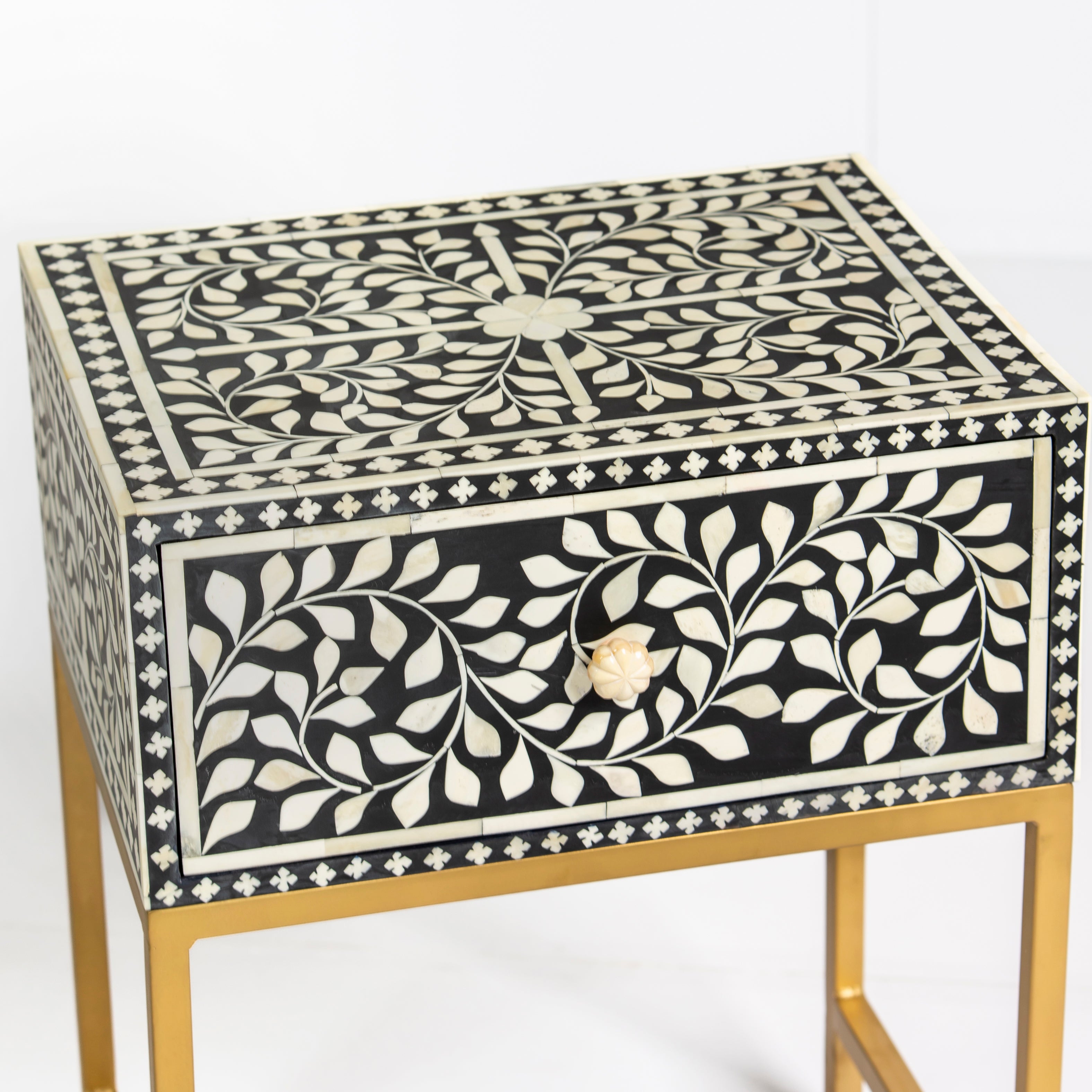 Bone inlay side drawer featuring floral vine pattern in black and white with metal base, handcrafted furniture piece