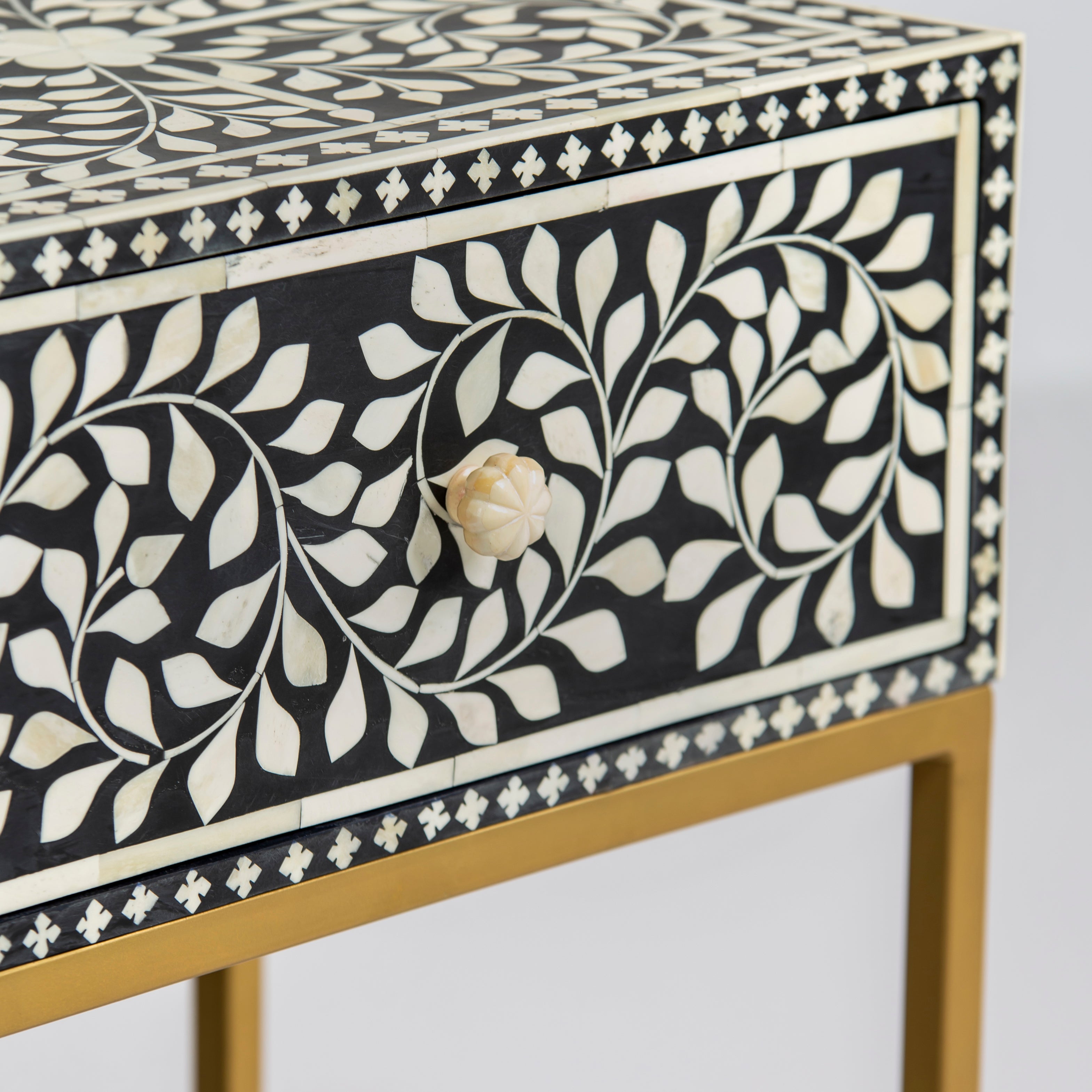 Bone inlay side drawer featuring floral vine pattern in black and white with metal base, handcrafted furniture piece