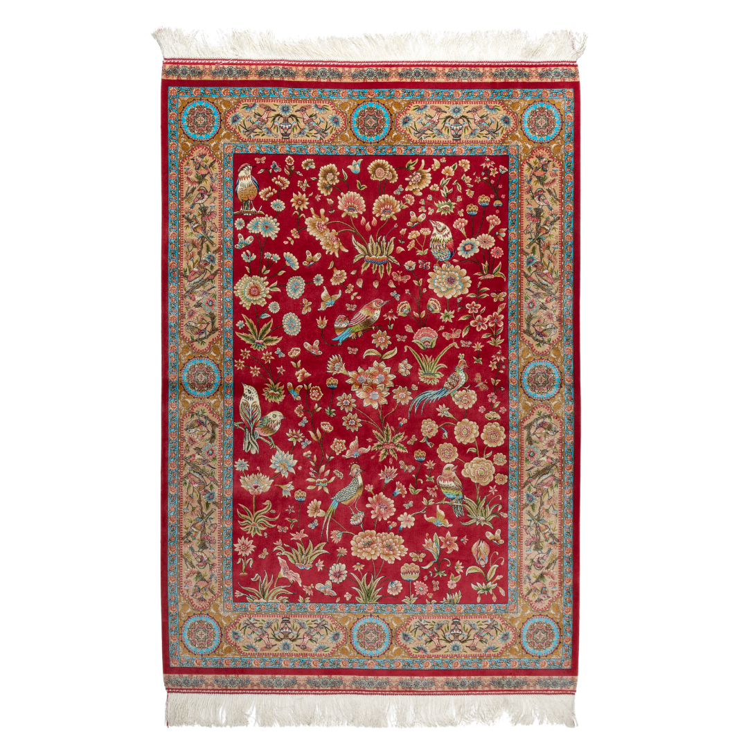 Crimson red silk rug featuring multi-colour floral and bird motifs, accented with turquoise, ivory, and gold detailing.