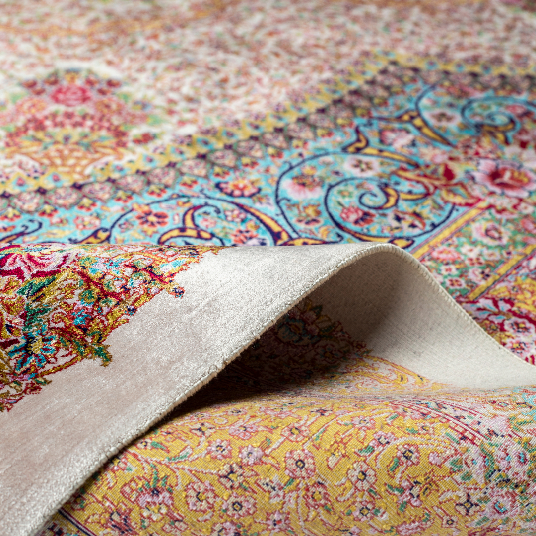 Silk Persian rug with a floral rosette medallion, ivory base, and ornate border in saffron, turquoise, plum, and blush tones.