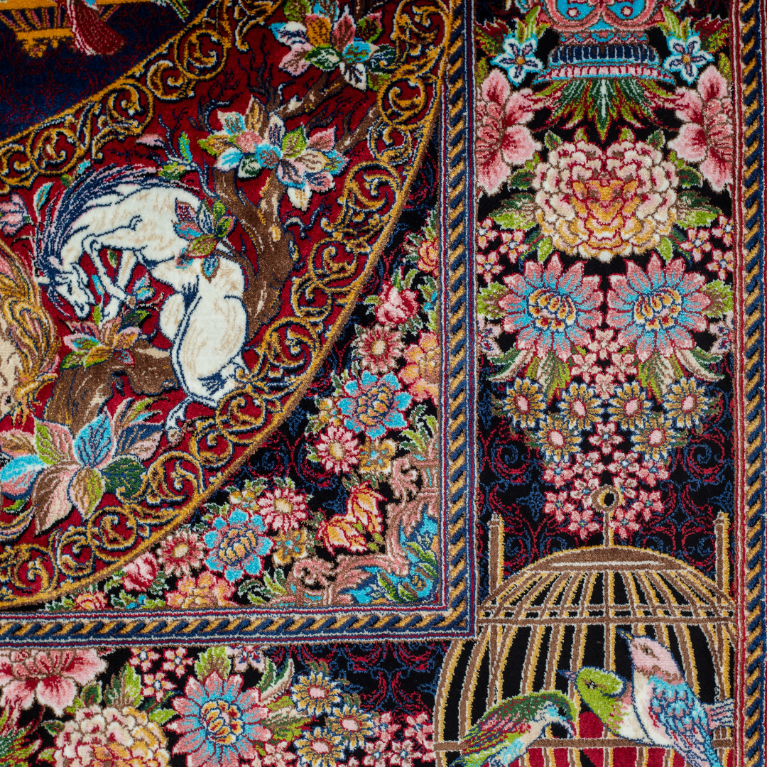 Vida silk rug with navy base, multi-colour birdcage motifs, floral accents, and detailed animal and garden scenes in 150x100 cm size.