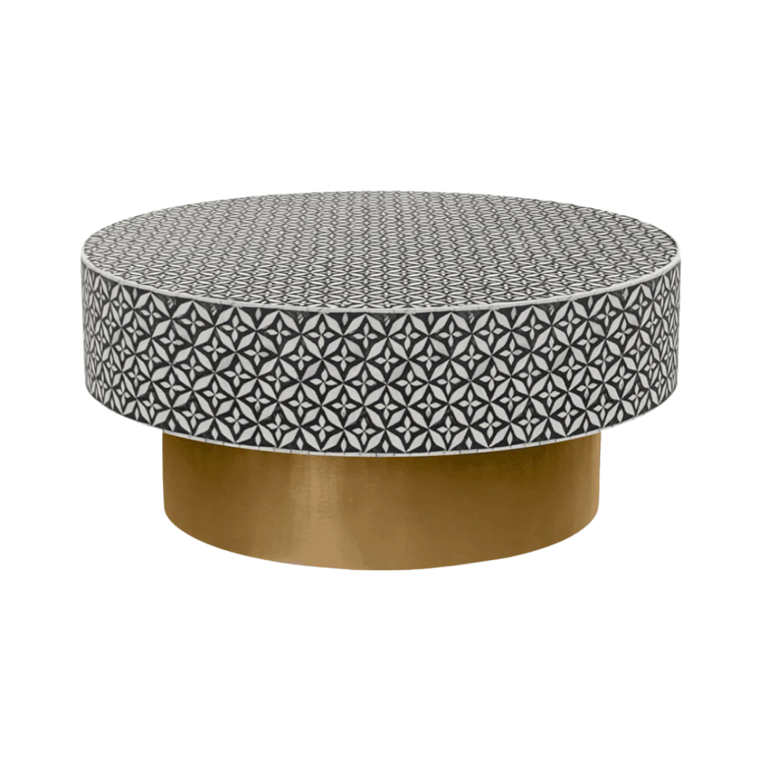 Round black bone inlay coffee table with intricate floral pattern and bold gold base. A modern, stylish centerpiece for any room.