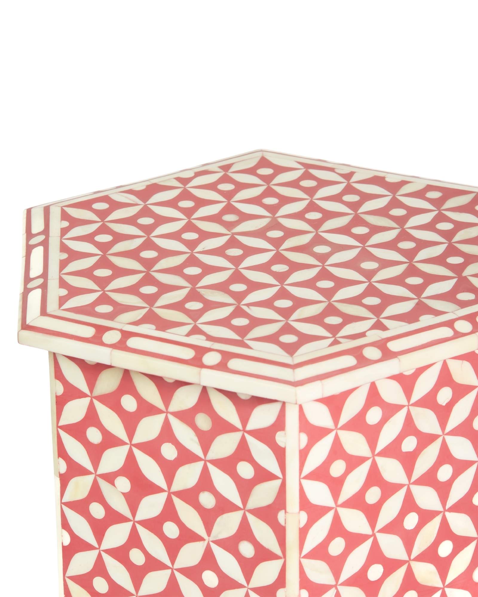Handcrafted Yasmine side table featuring pink bone inlay with a hexagonal silhouette, geometric detailing, and arched legs.