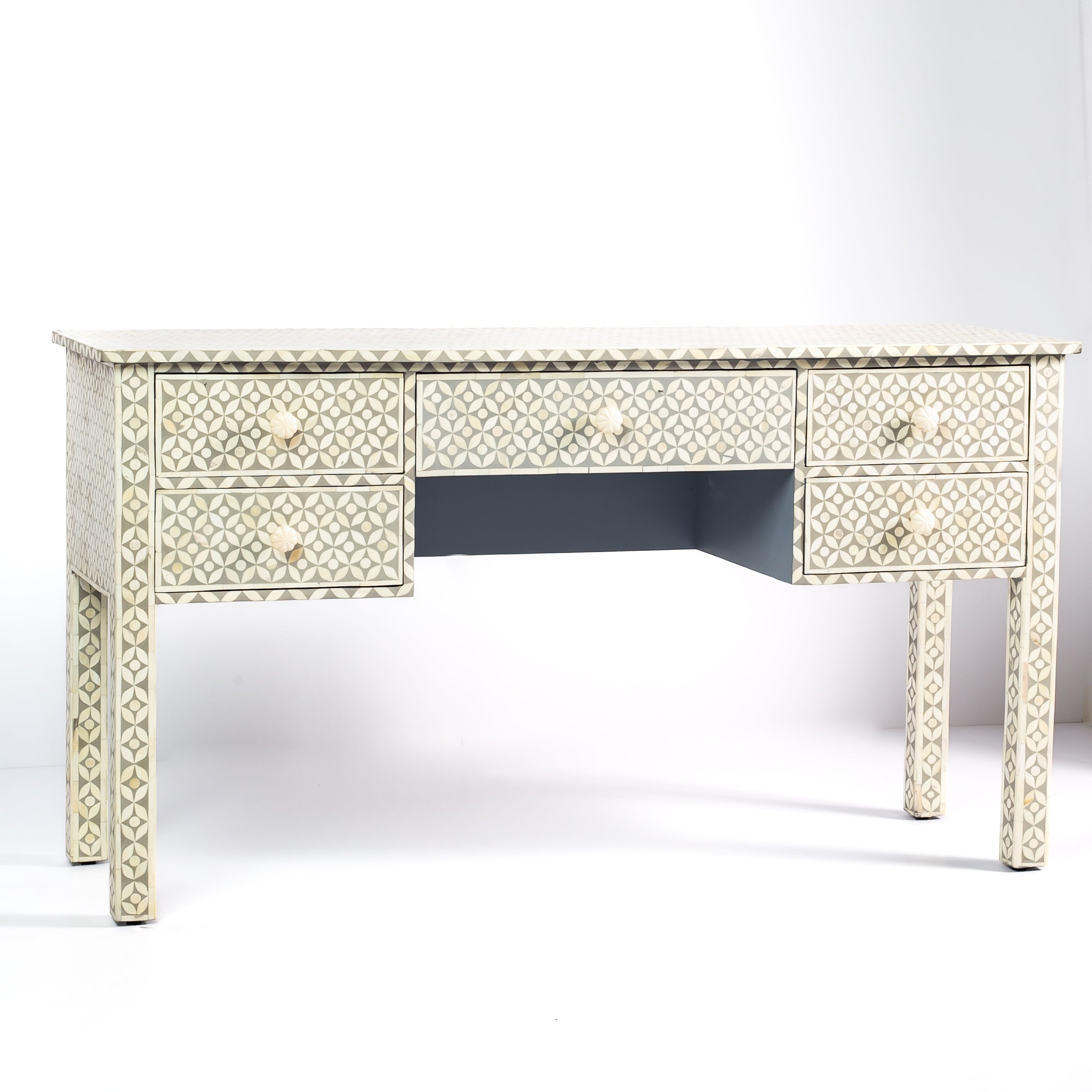 Grey bone inlay console desk with five drawers and geometric design, handcrafted with detailed knobs and artisan craftsmanship.
