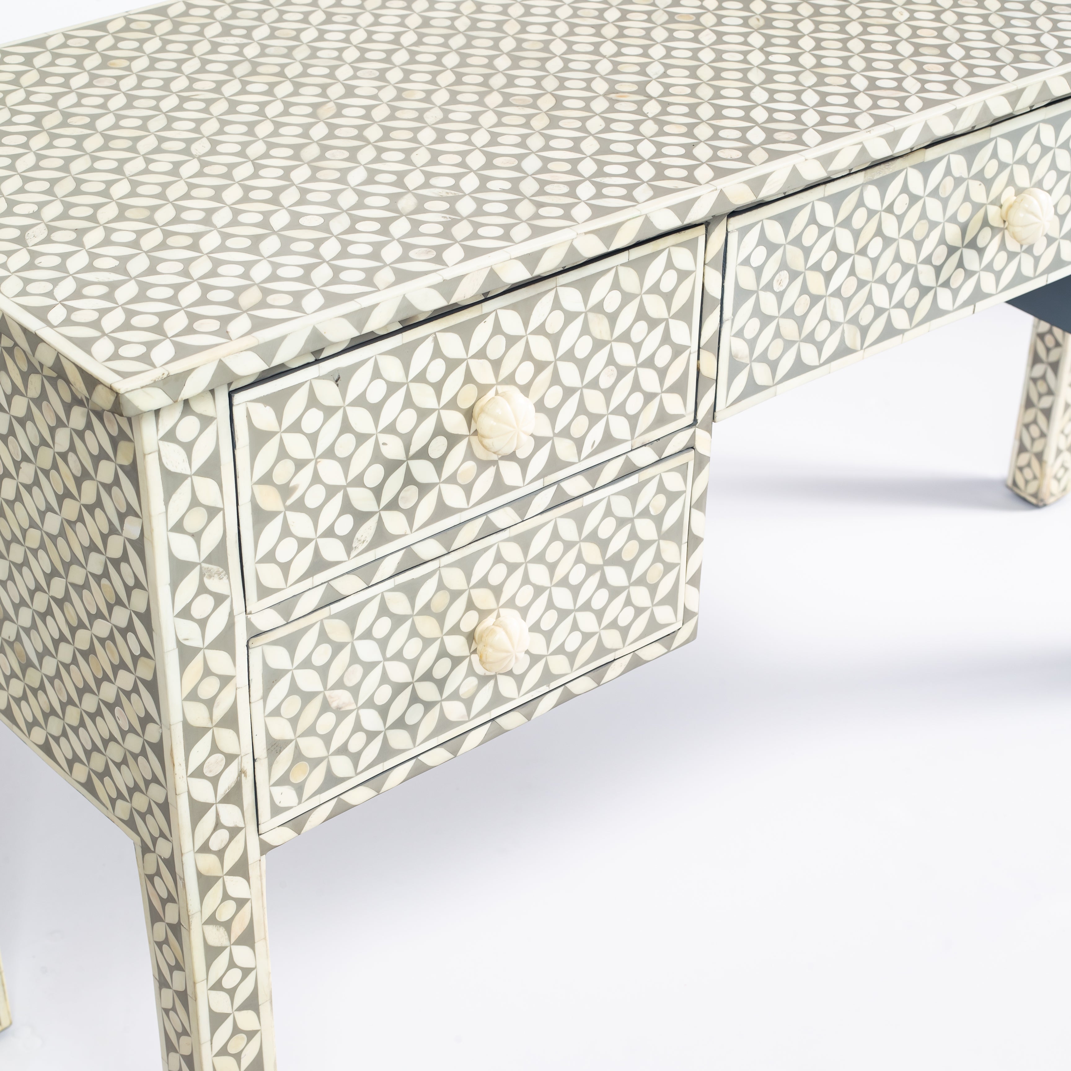 Grey bone inlay console desk with five drawers and geometric design, handcrafted with detailed knobs and artisan craftsmanship.