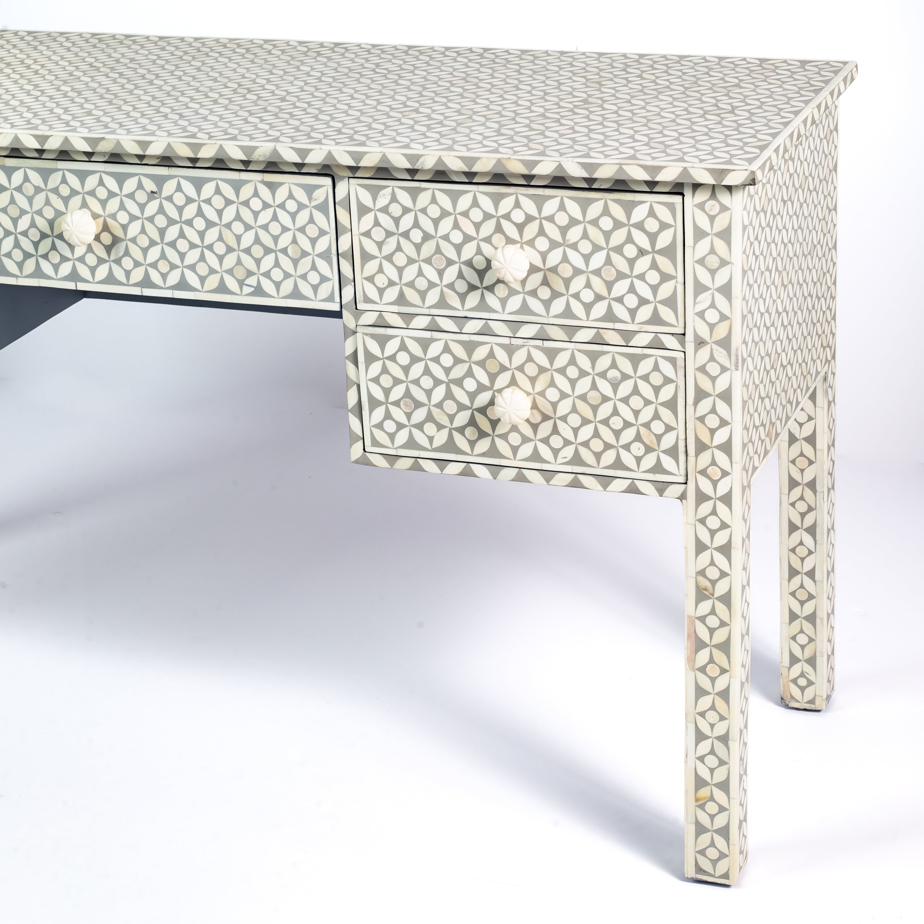 Grey bone inlay console desk with five drawers and geometric design, handcrafted with detailed knobs and artisan craftsmanship.
