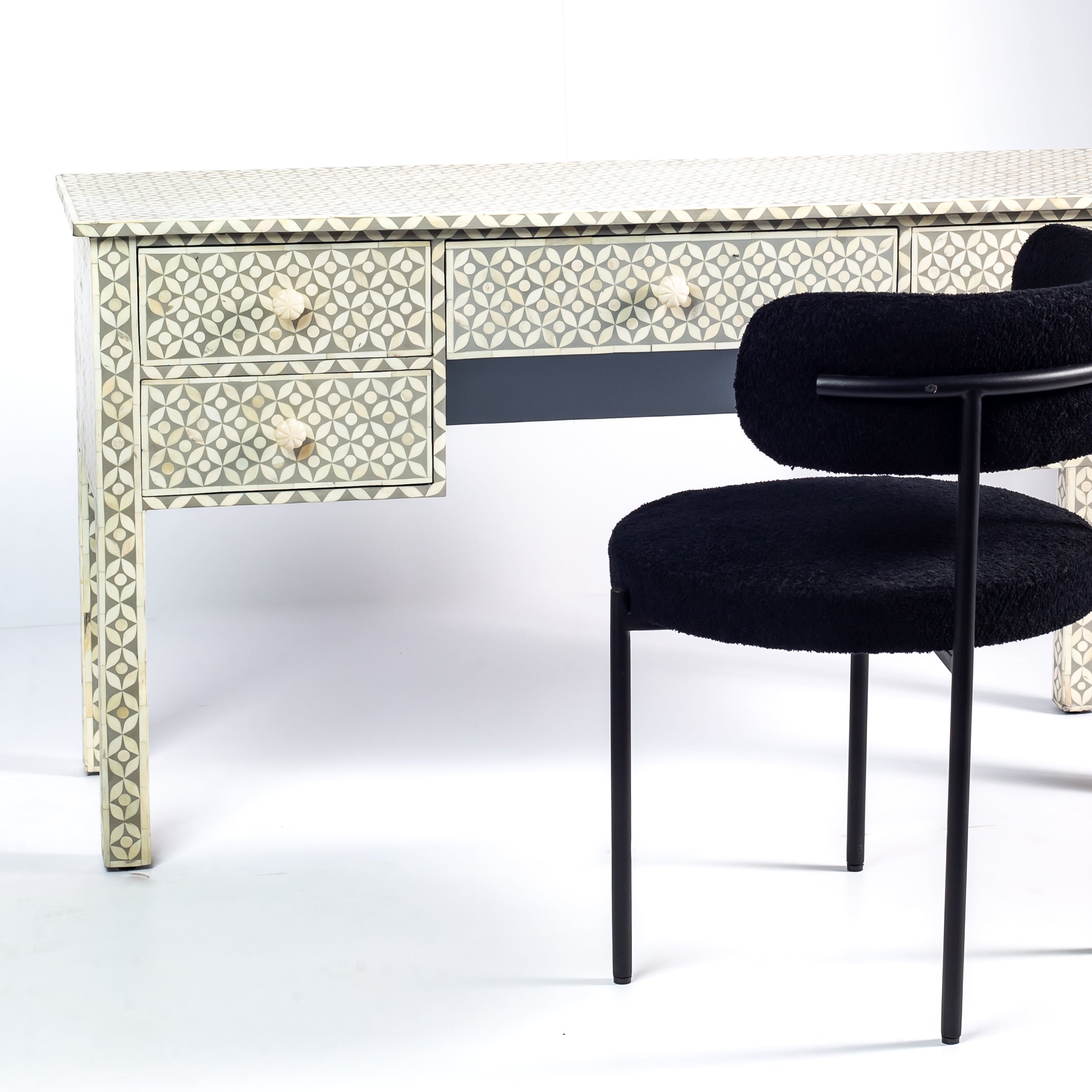 Grey bone inlay console desk with five drawers and geometric design, handcrafted with detailed knobs and artisan craftsmanship.