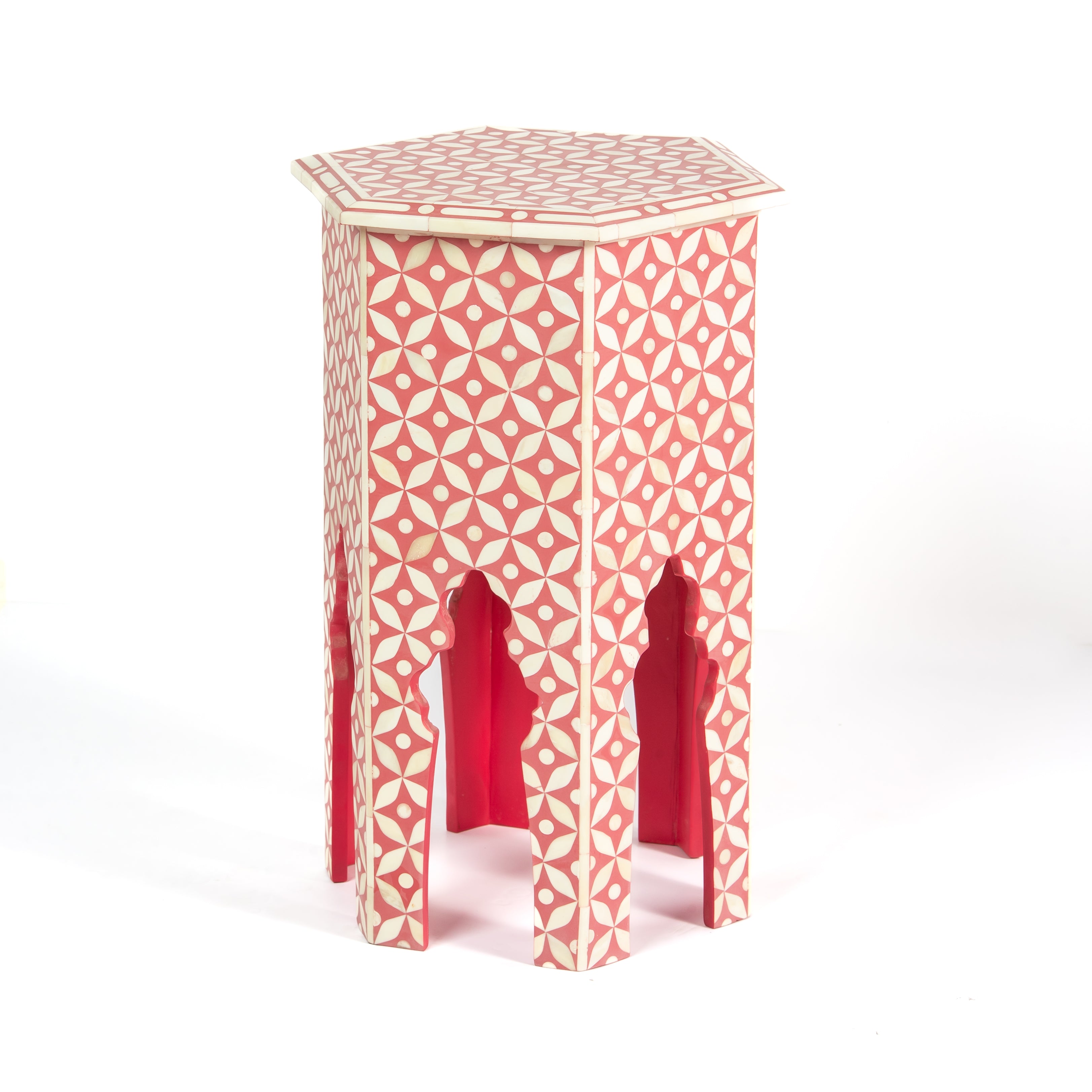 Handcrafted Yasmine side table featuring pink bone inlay with a hexagonal silhouette, geometric detailing, and arched legs.