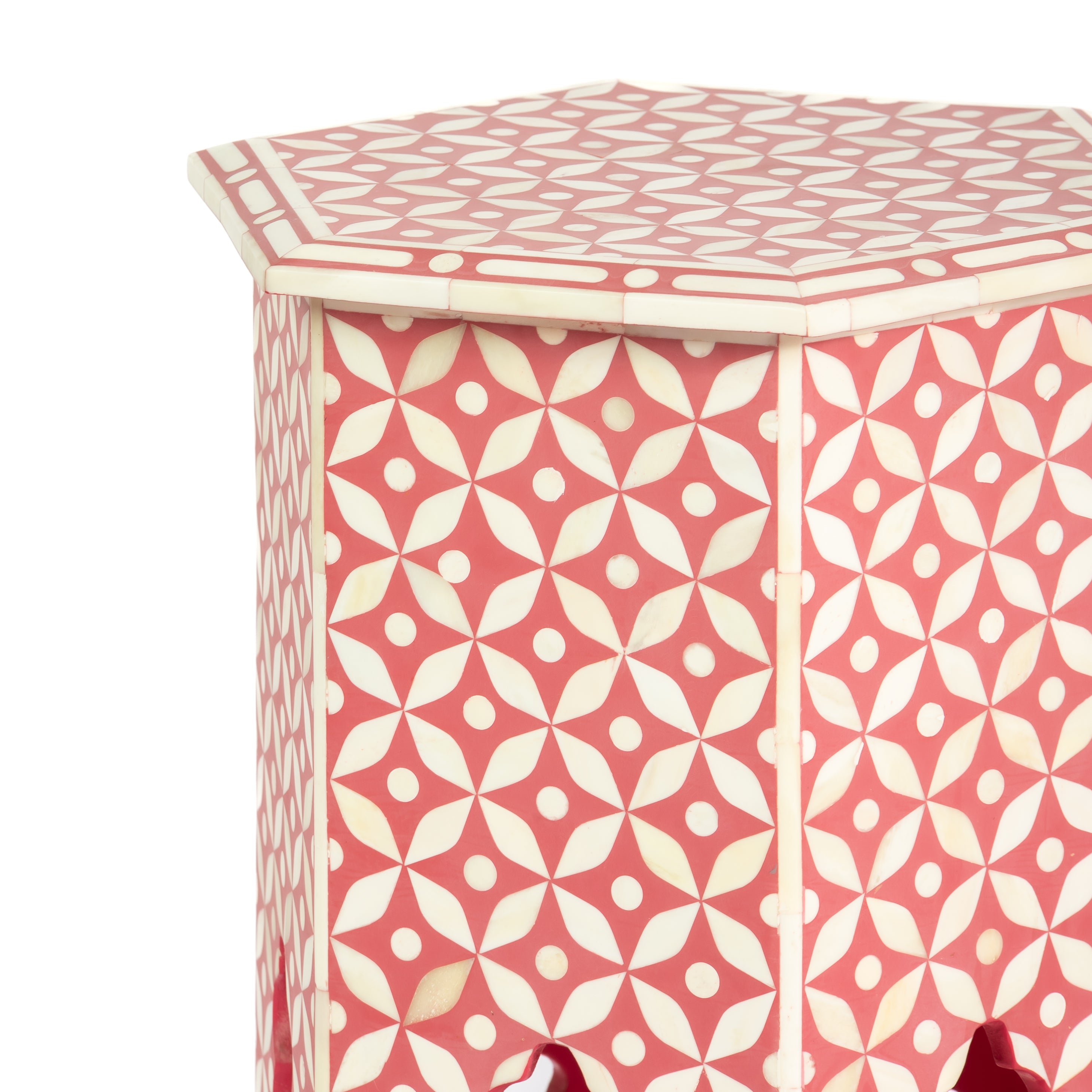 Handcrafted Yasmine side table featuring pink bone inlay with a hexagonal silhouette, geometric detailing, and arched legs.