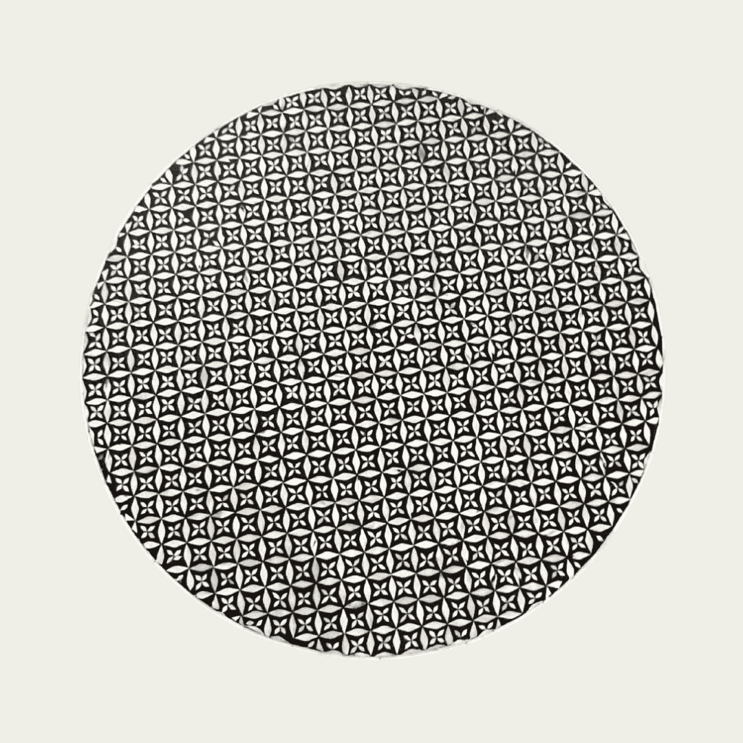 Round black bone inlay coffee table with intricate floral pattern and bold gold base. A modern, stylish centerpiece for any room.