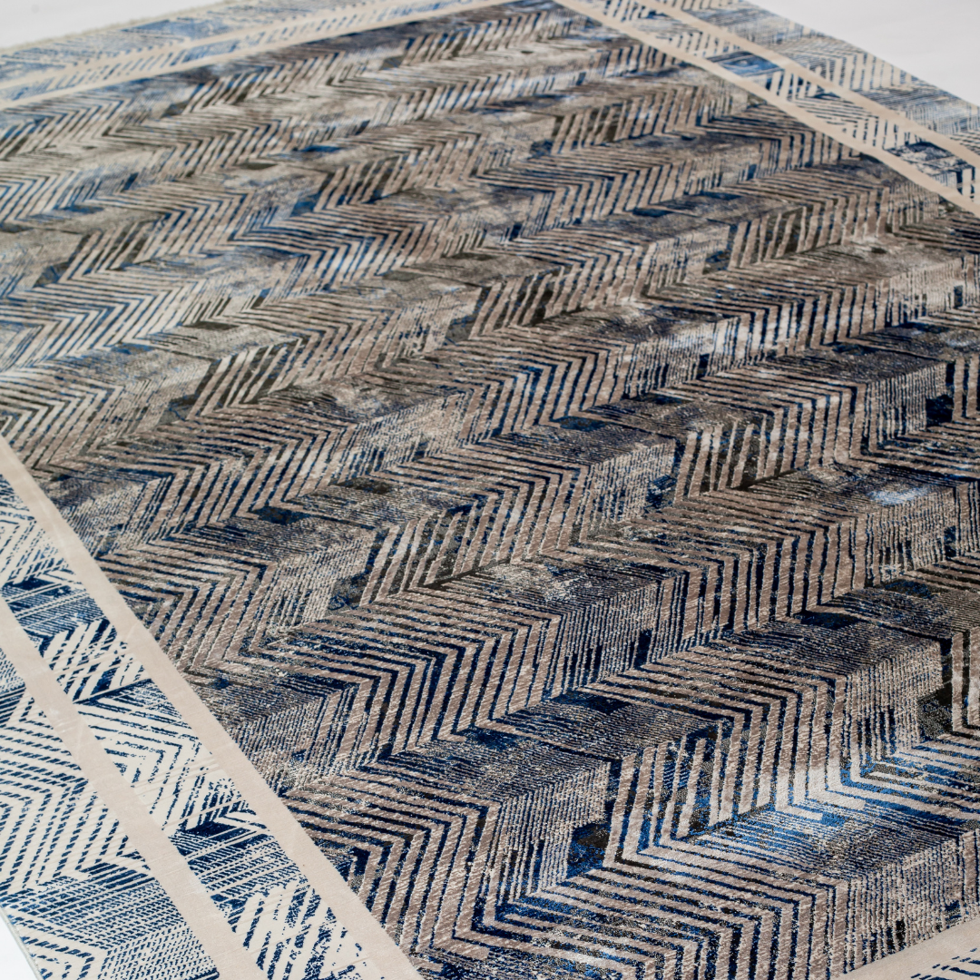 Zira cotton rug featuring a bold chevron pattern in grey, blue, and ivory with a distressed texture, perfect for contemporary interiors.
