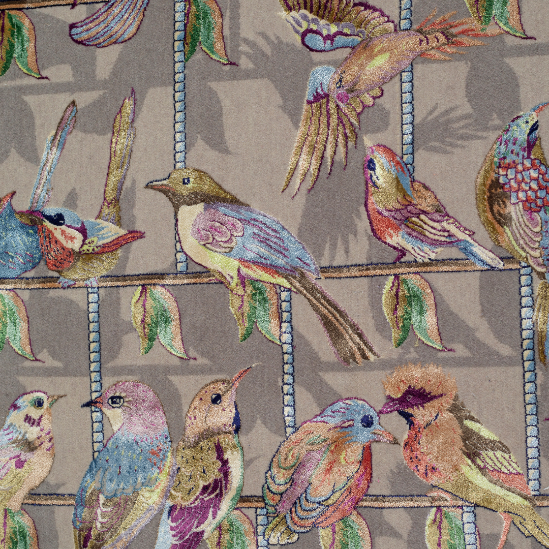 Handwoven silk rug featuring birds on a beige grid, floral corners, and classical columns. A joyful yet elegant statement piece.