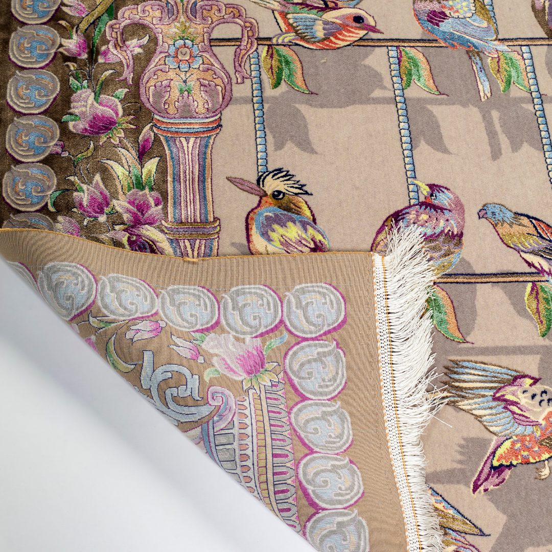 Handwoven silk rug featuring birds on a beige grid, floral corners, and classical columns. A joyful yet elegant statement piece.