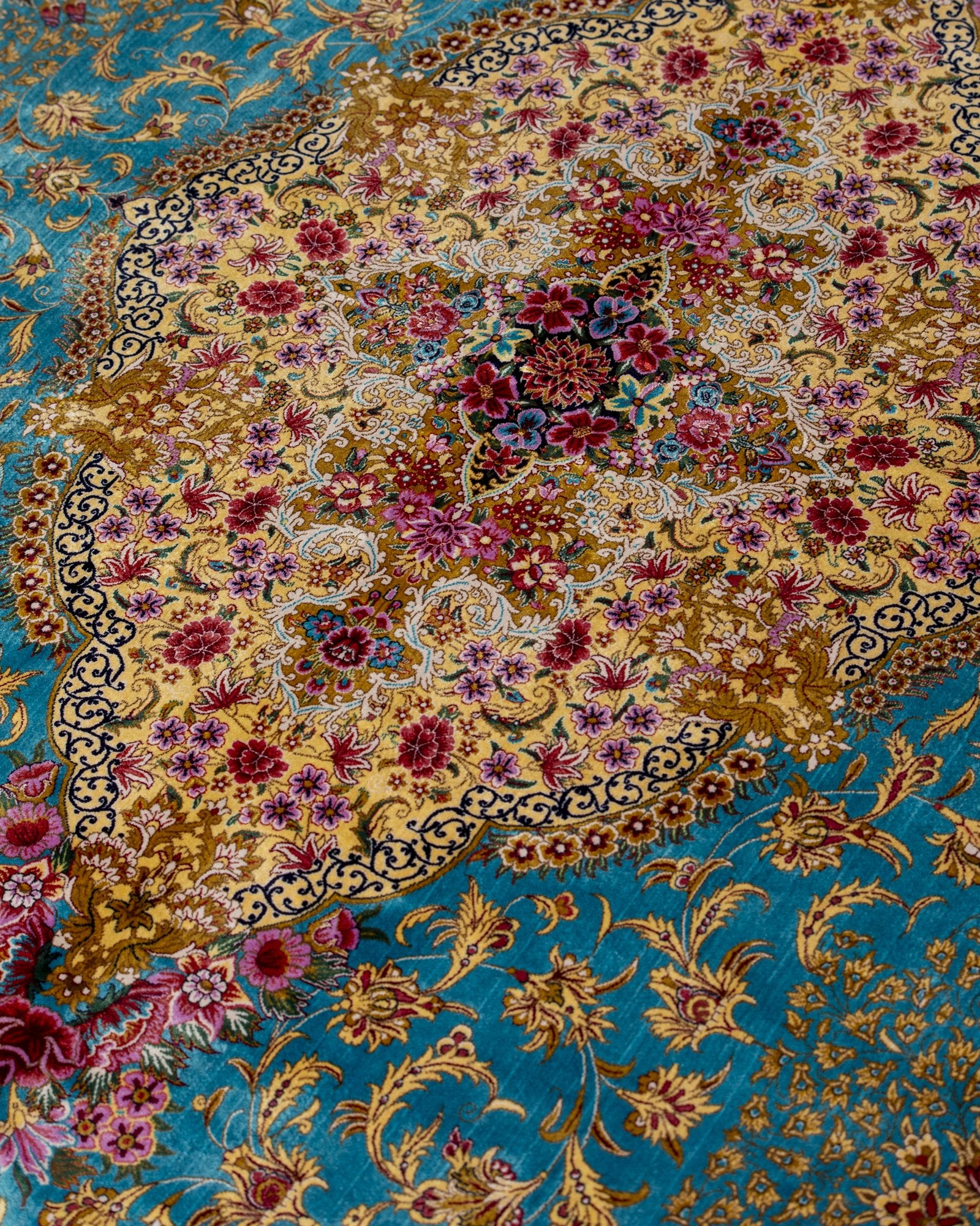 border and field detail on the Aurelia teal silk rug