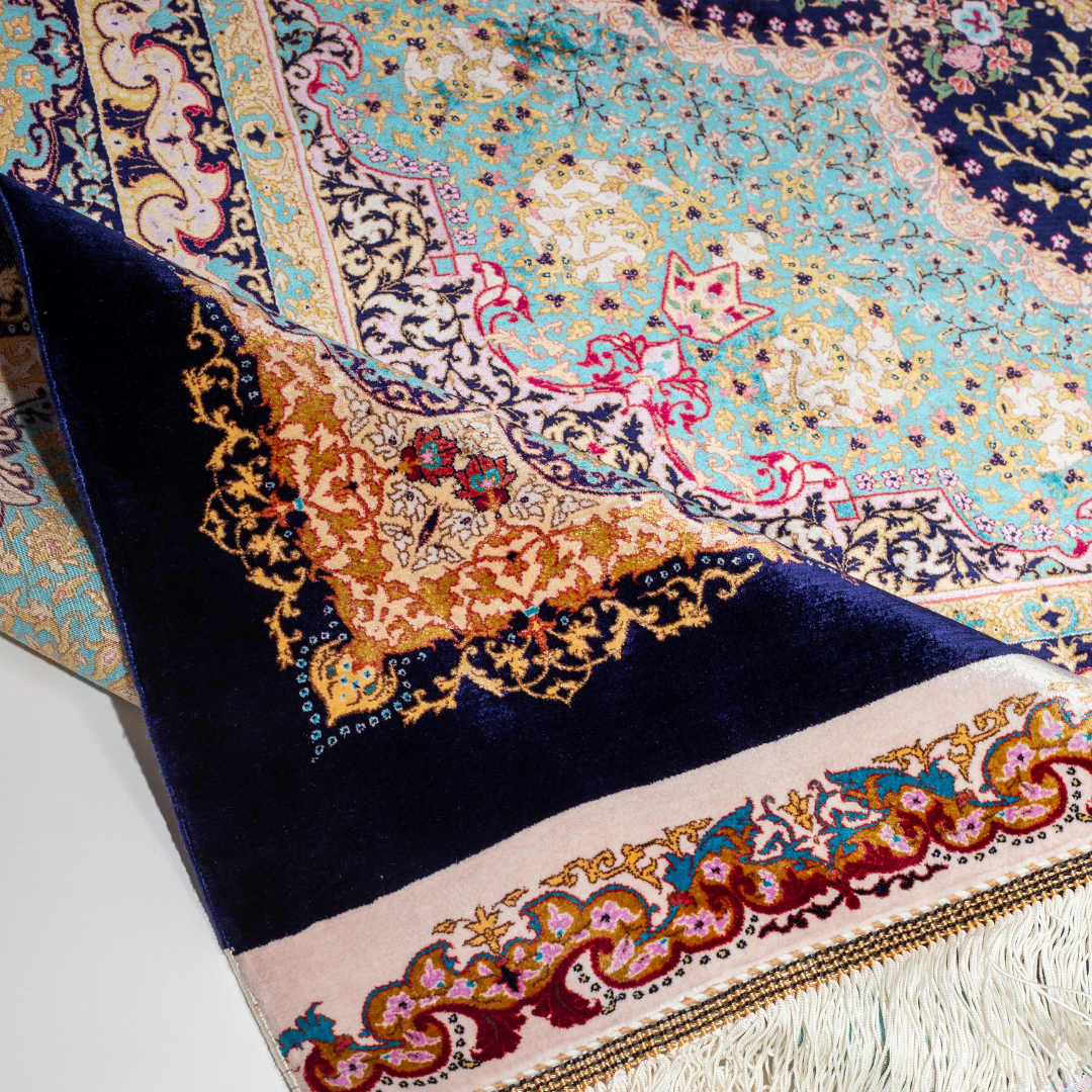 Azarine Silk Rug in 200x300 cm featuring a navy base, turquoise medallion, and intricate floral motifs.