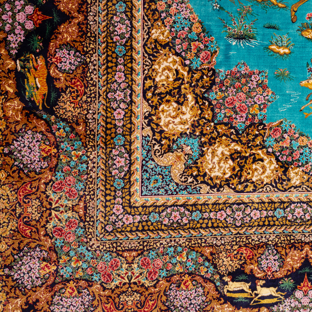 Vibrant handwoven silk rug with a turquoise base, animal motifs, hunting scenes, and floral detailing in gold and pink tones.