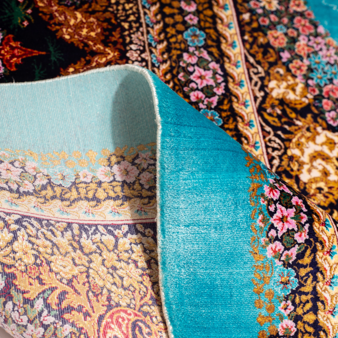 Vibrant handwoven silk rug with a turquoise base, animal motifs, hunting scenes, and floral detailing in gold and pink tones.