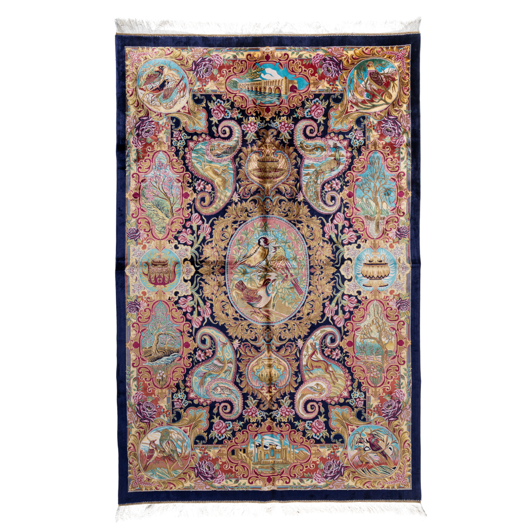 Silk rug with tree of life and bird motif, burgundy floral base, and ornate navy-gold borders. Handwoven with artistic precision.
