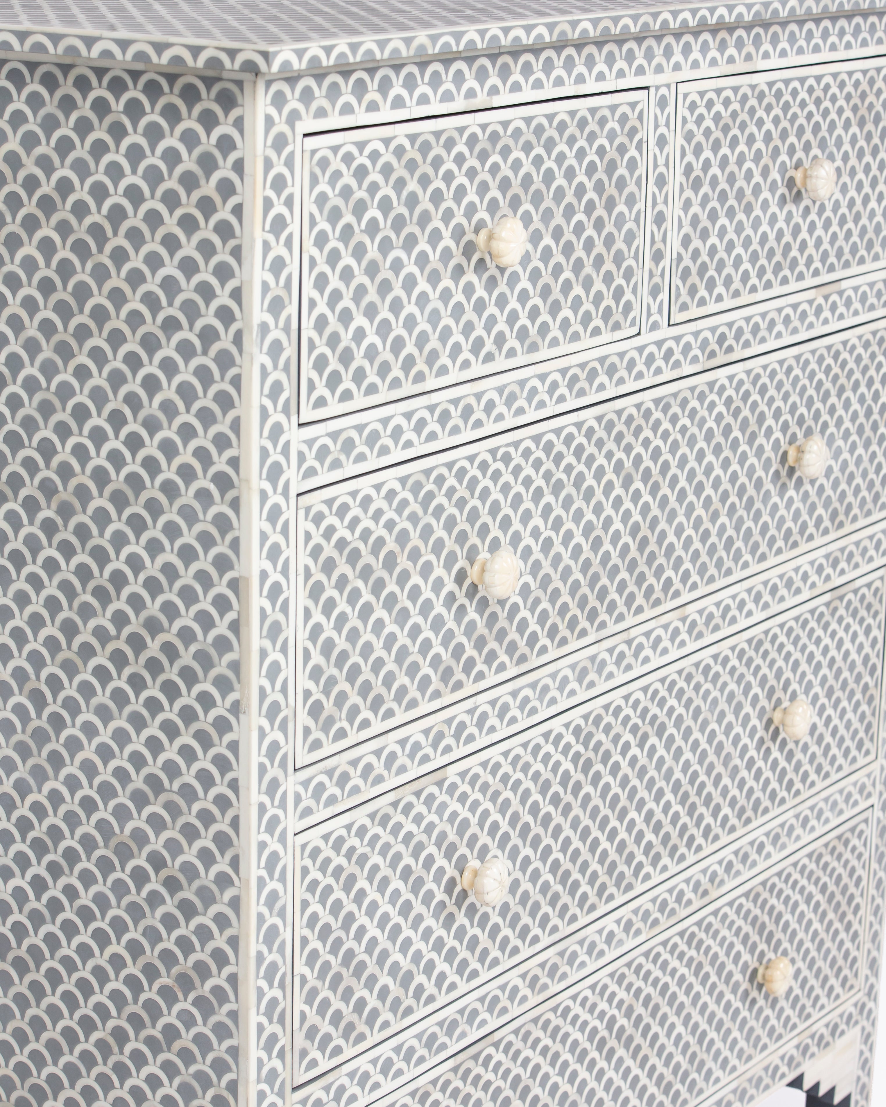 Close up of grey and white fish scale bone inlay with bone knobs