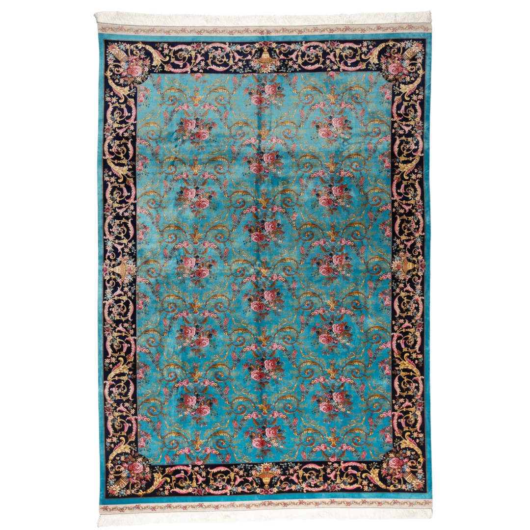 The Bellamy silk rug in turquoise with red floral motifs and golden scrolls, featuring a black ornamental border and exquisite handwoven detailing.