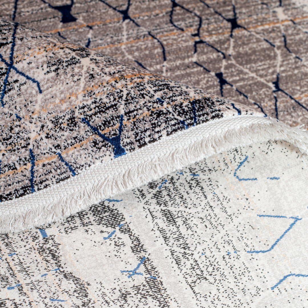 Caldre cotton Rug in 200x300 cms with a distressed ivory base, taupe texture, and navy geometric lattice design, perfect for contemporary living spaces.