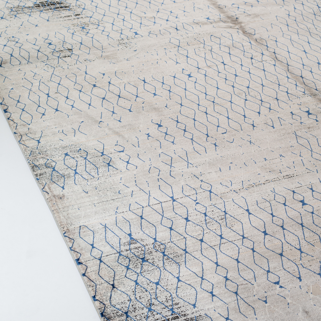 Caldre cotton Rug in 200x300 cms with a distressed ivory base, taupe texture, and navy geometric lattice design, perfect for contemporary living spaces.