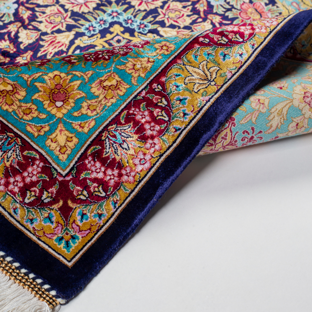 Luxurious silk rug with intricate medallion and floral design in jewel tones. Elegant handwoven detailing for sophisticated interiors.