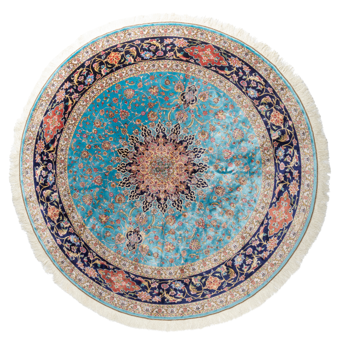 Celina Silk Rug with a turquoise base, intricate central floral medallion, and ornate navy border with Persian floral motifs and fine silk texture.