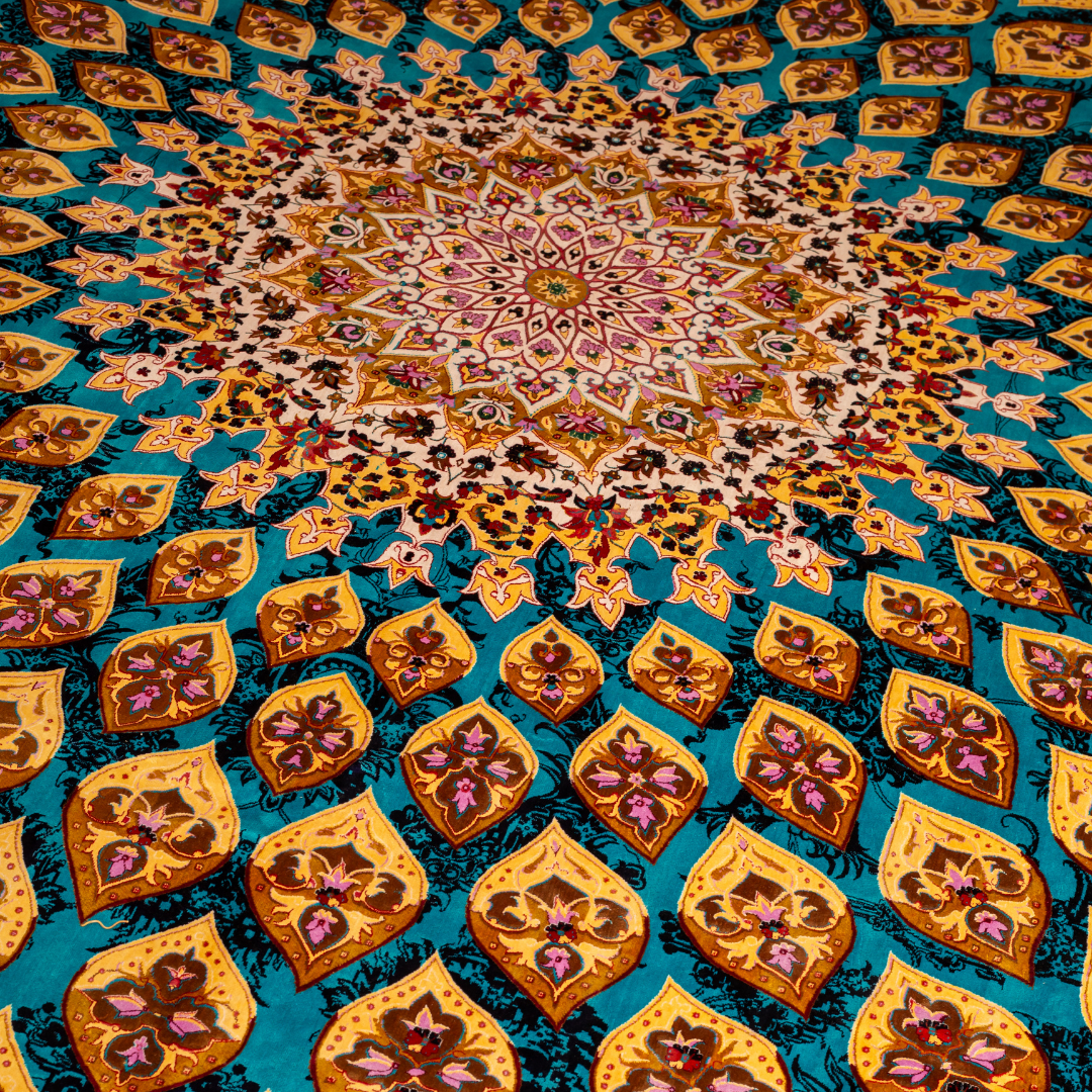 Elowen silk rug in 350x250 cms featuring turquoise and mustard floral designs with a detailed medallion and golden border work.