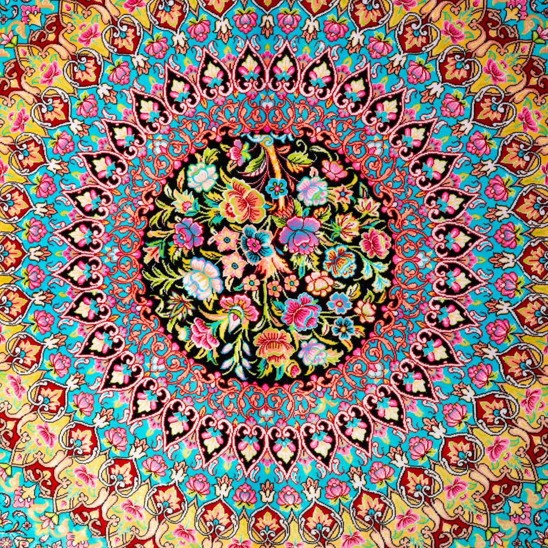 Luxurious silk rug featuring a central medallion in turquoise and pink, floral vases in corners, and ornate borders on a dark base.