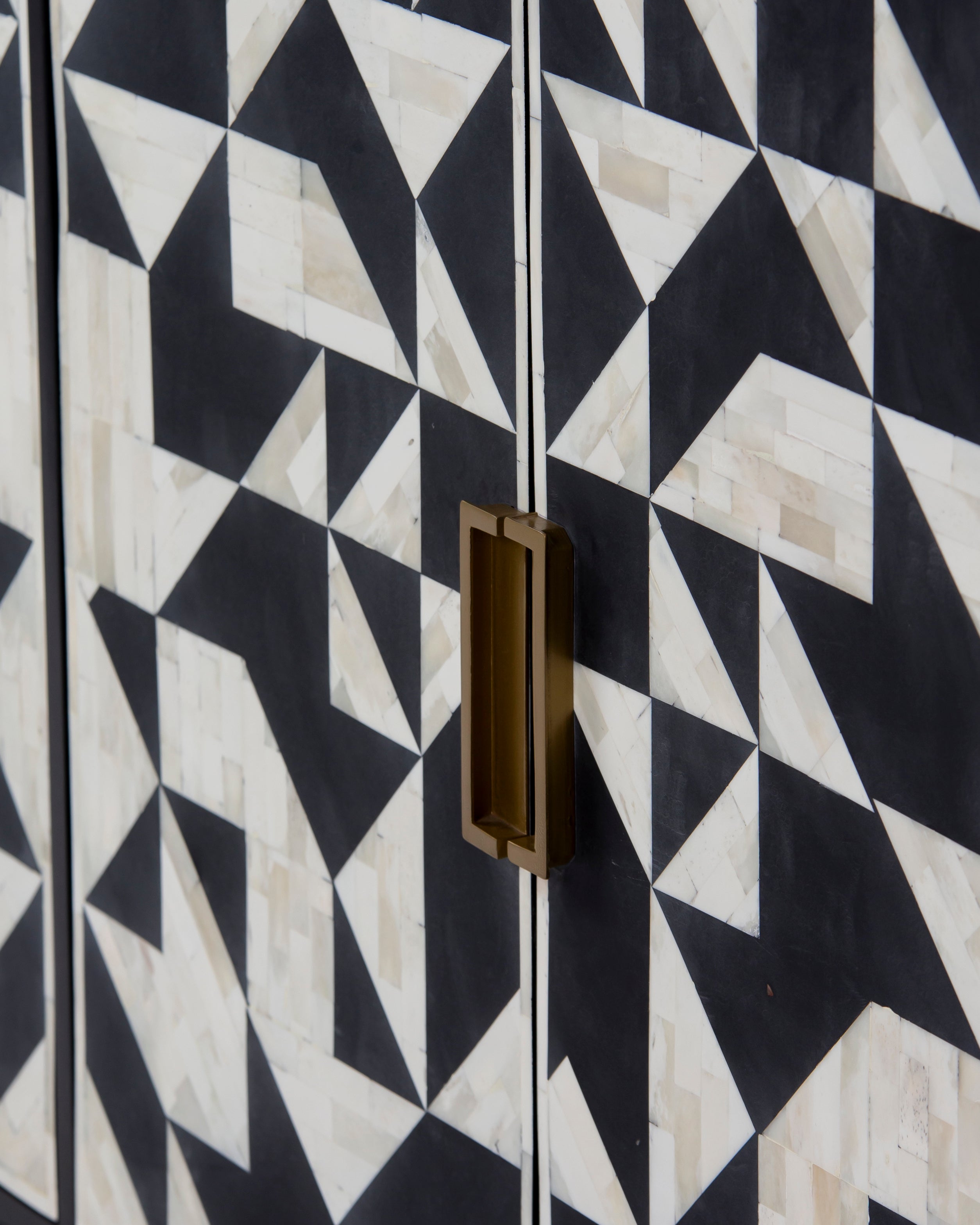 Close up of brass handle and bone inlay pattern on Eve cabinet