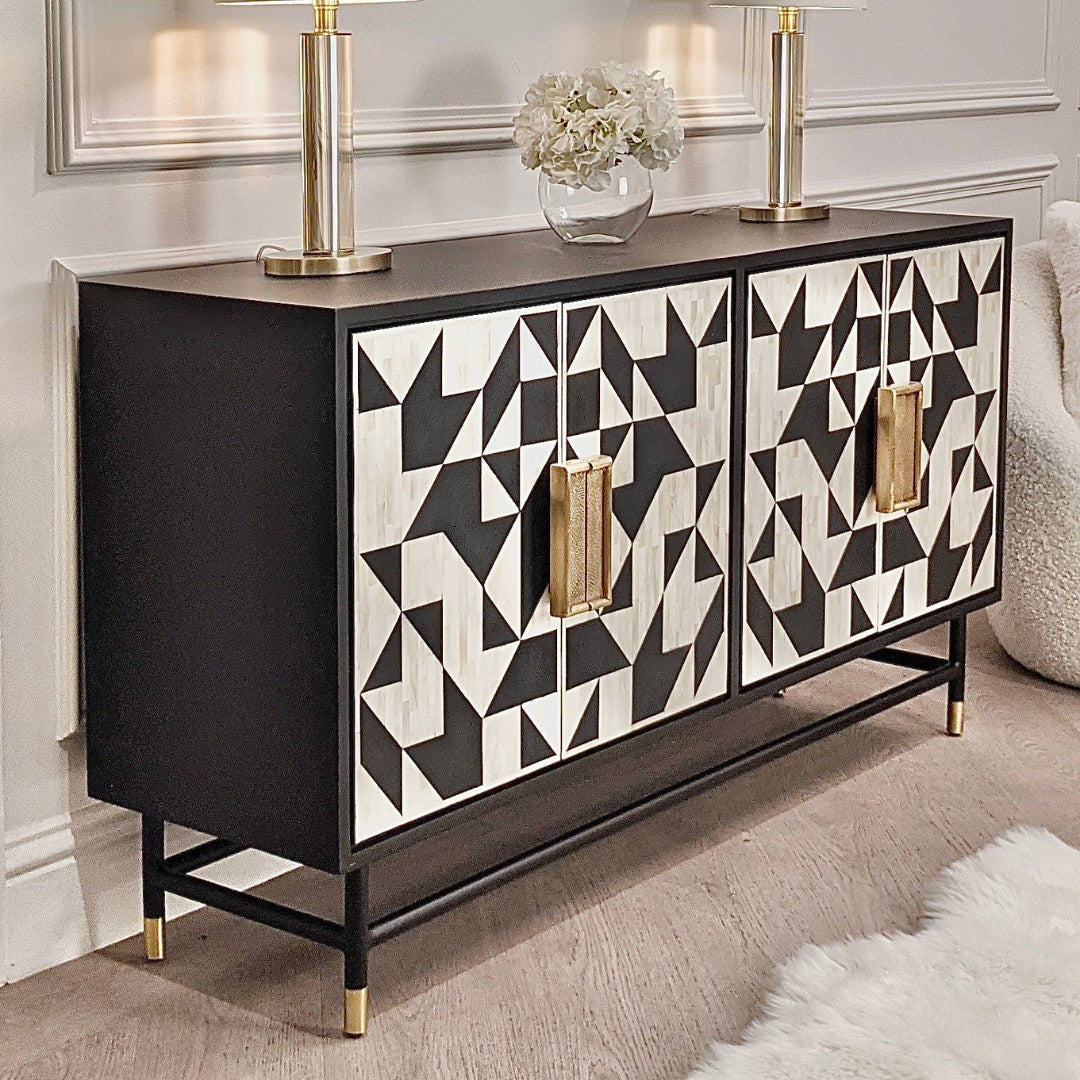 Elegant black bone inlay cabinet with geometric patterns, gold handles, and slim legs, perfect for a statement living space.