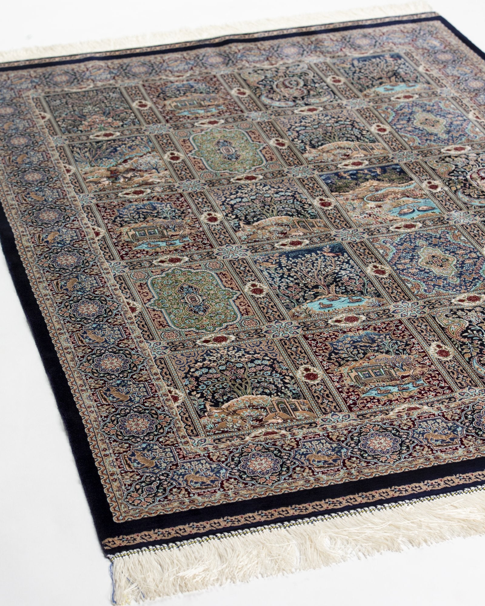 close view of the garden panel on the Golbahar navy silk rug