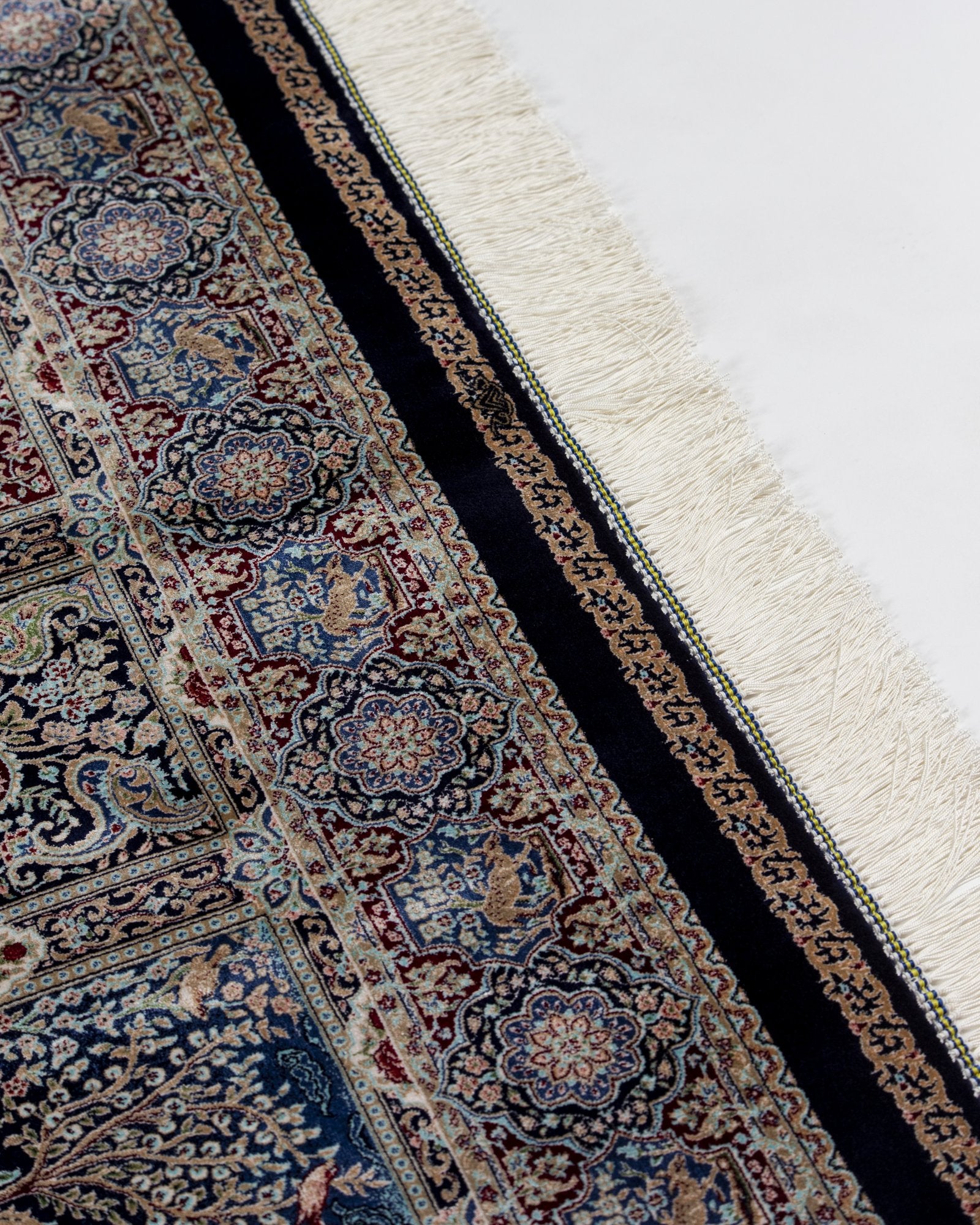 corner with silk fringe on the Golbahar navy silk rug
