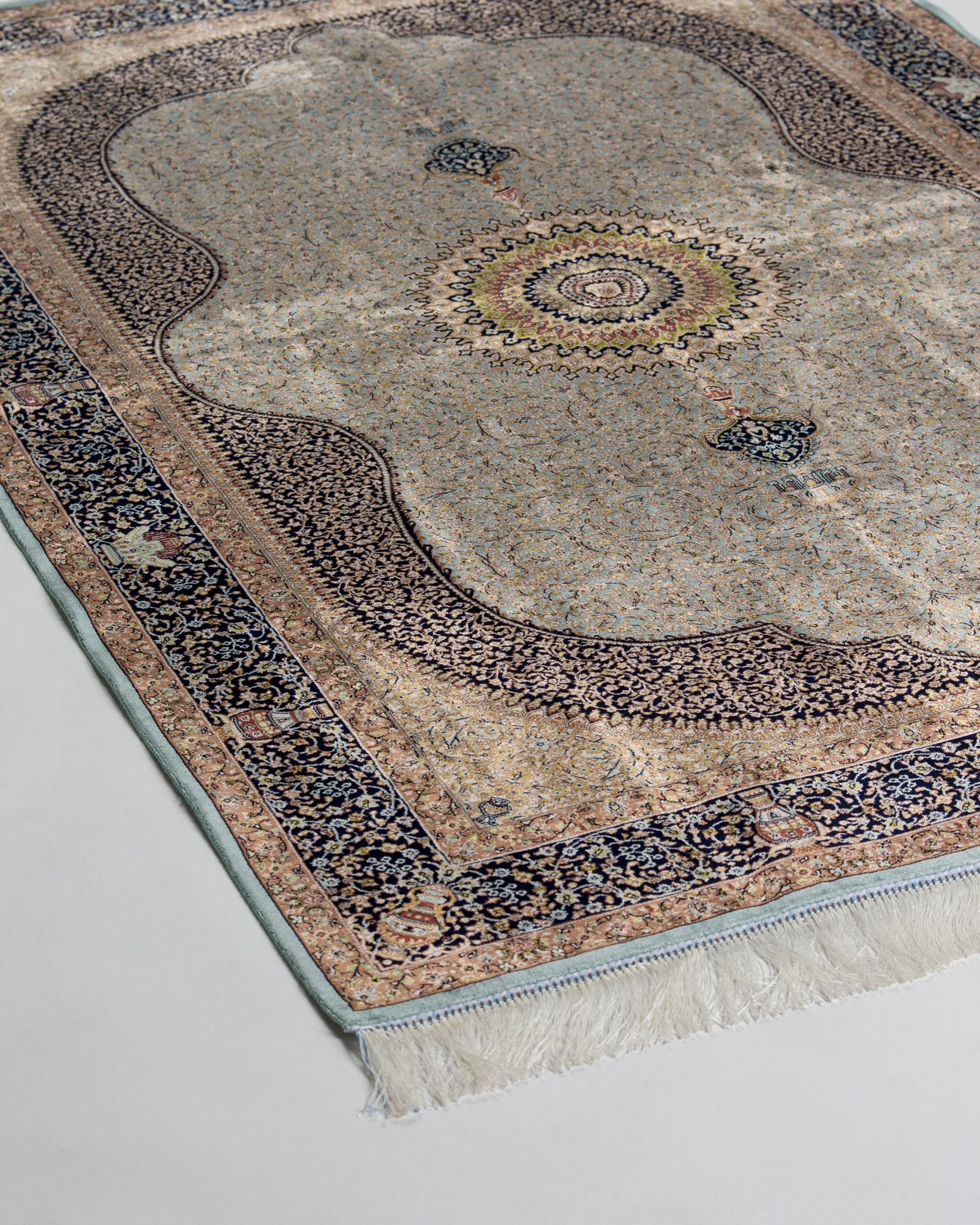 close view of the sunburst medallion on the Celeste taupe silk rug